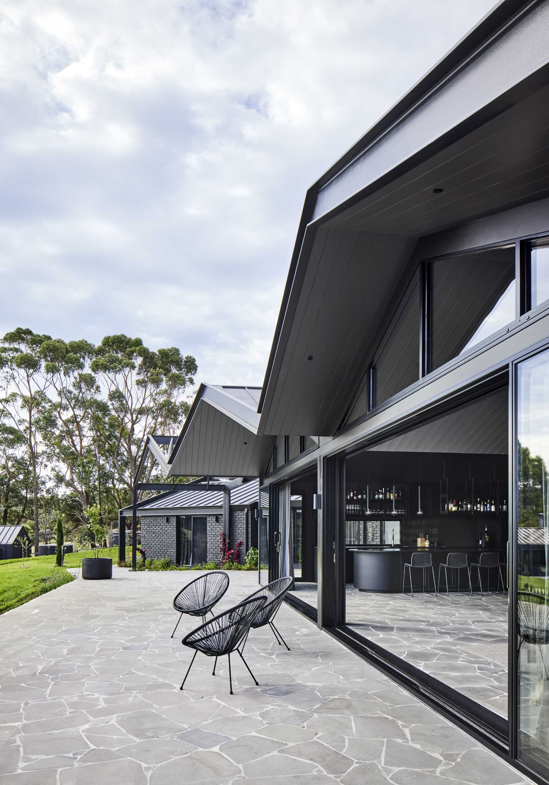 A modern farmhouse with bluestone crazy paving featured on the terrace and the interior.