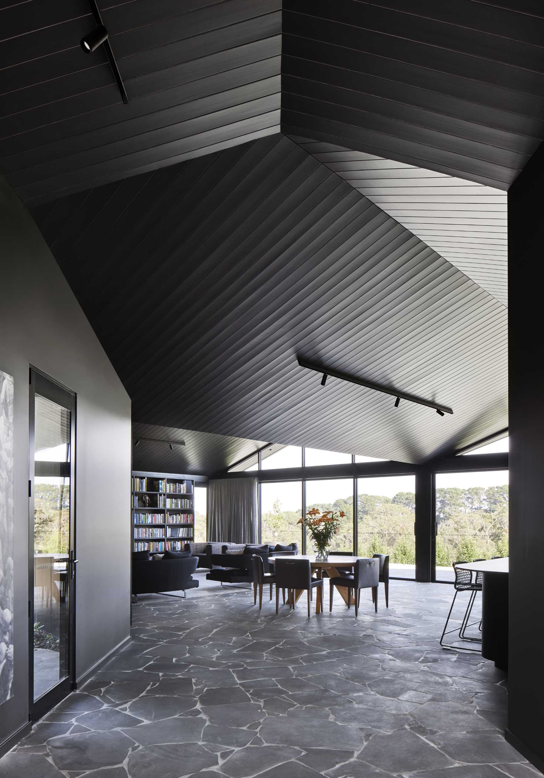 This lining board ceiling that follows the undulating roof line is a reference to the coastal cladding characteristic of homes in this area and accentuates the sculptural form of the old building blending with the new.