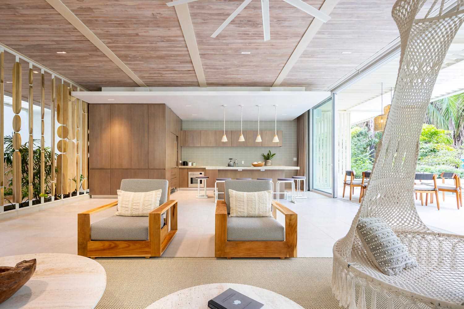 A modern open plan interior with a wood kitchen.