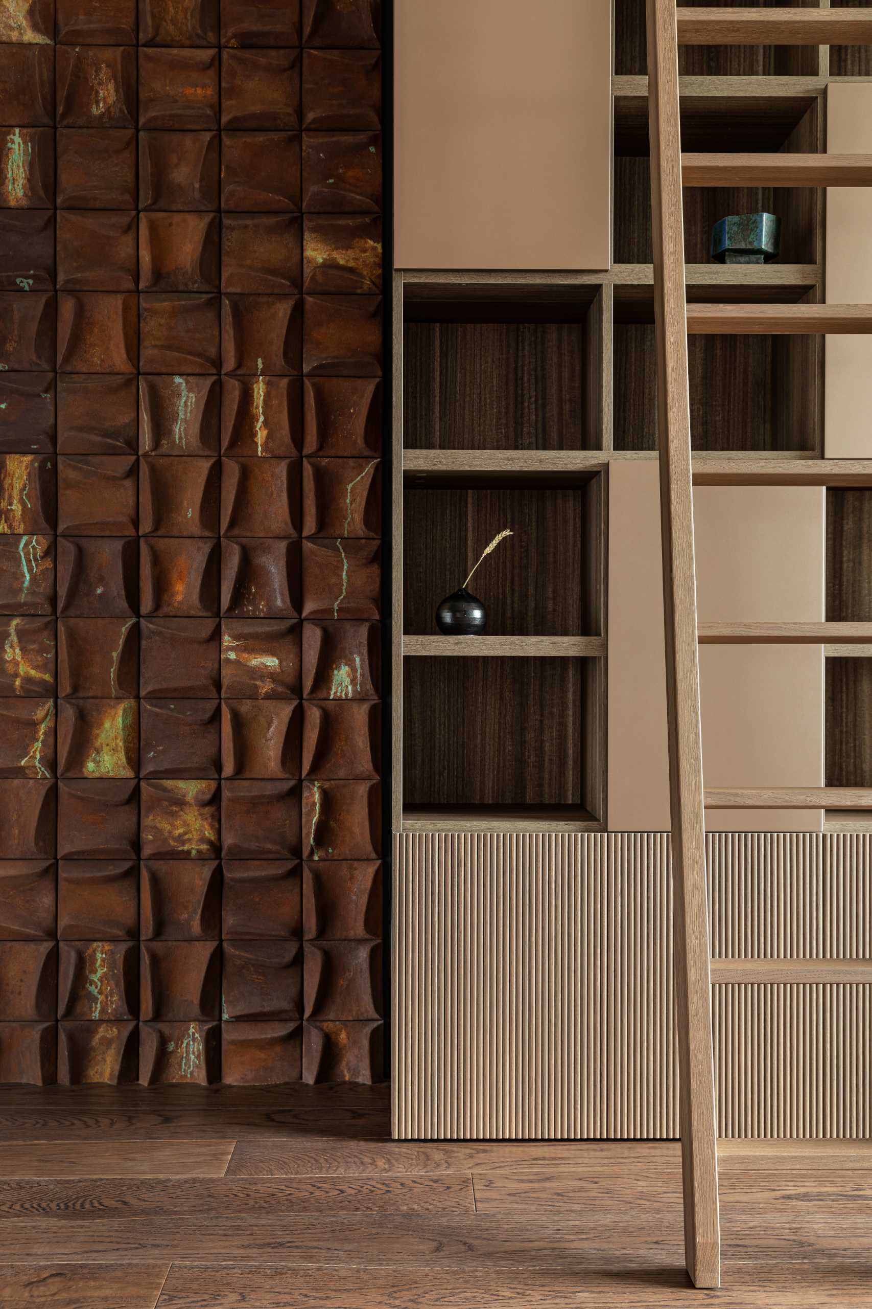 A library that includes an accent wall that showcases a 3-dimensional tile named Drozh.