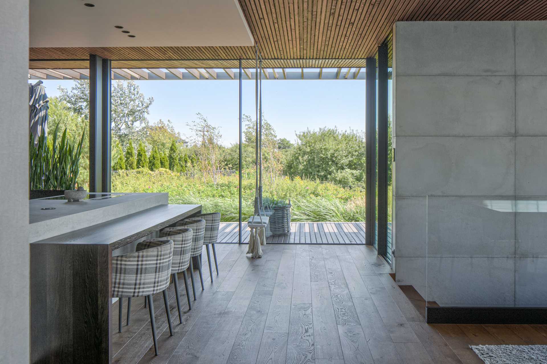 A modern kitchen with a sliding glass door that allows access to the deck.