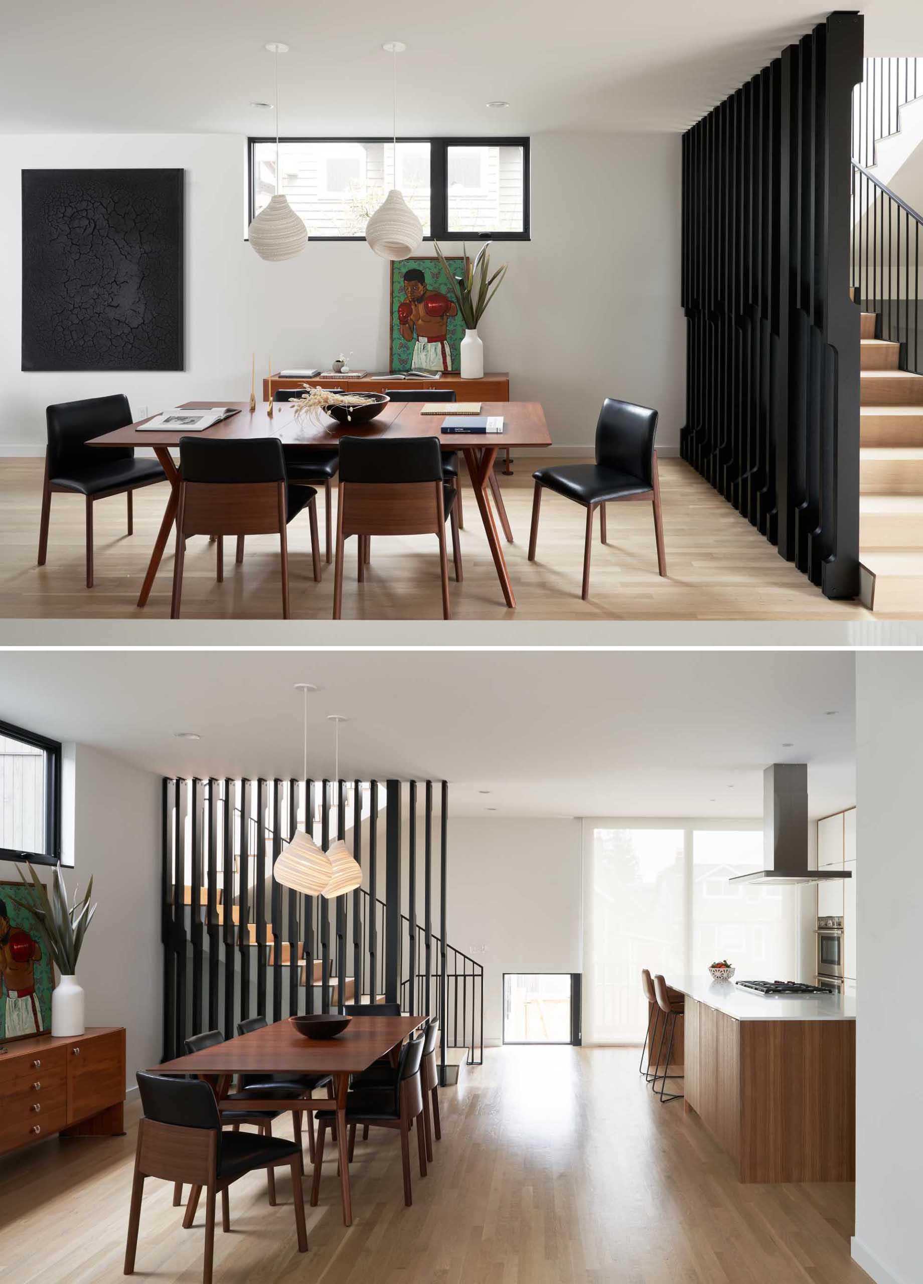 A modern dining room with a warm wood table and a pair of sculptural pendant lights.