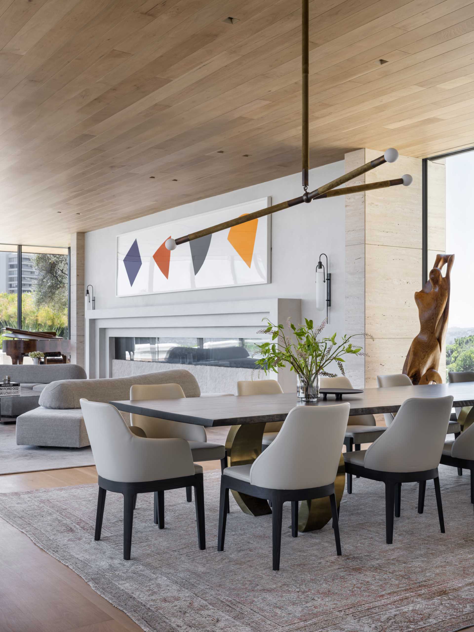 A modern open-plan dining area with a large wood table.