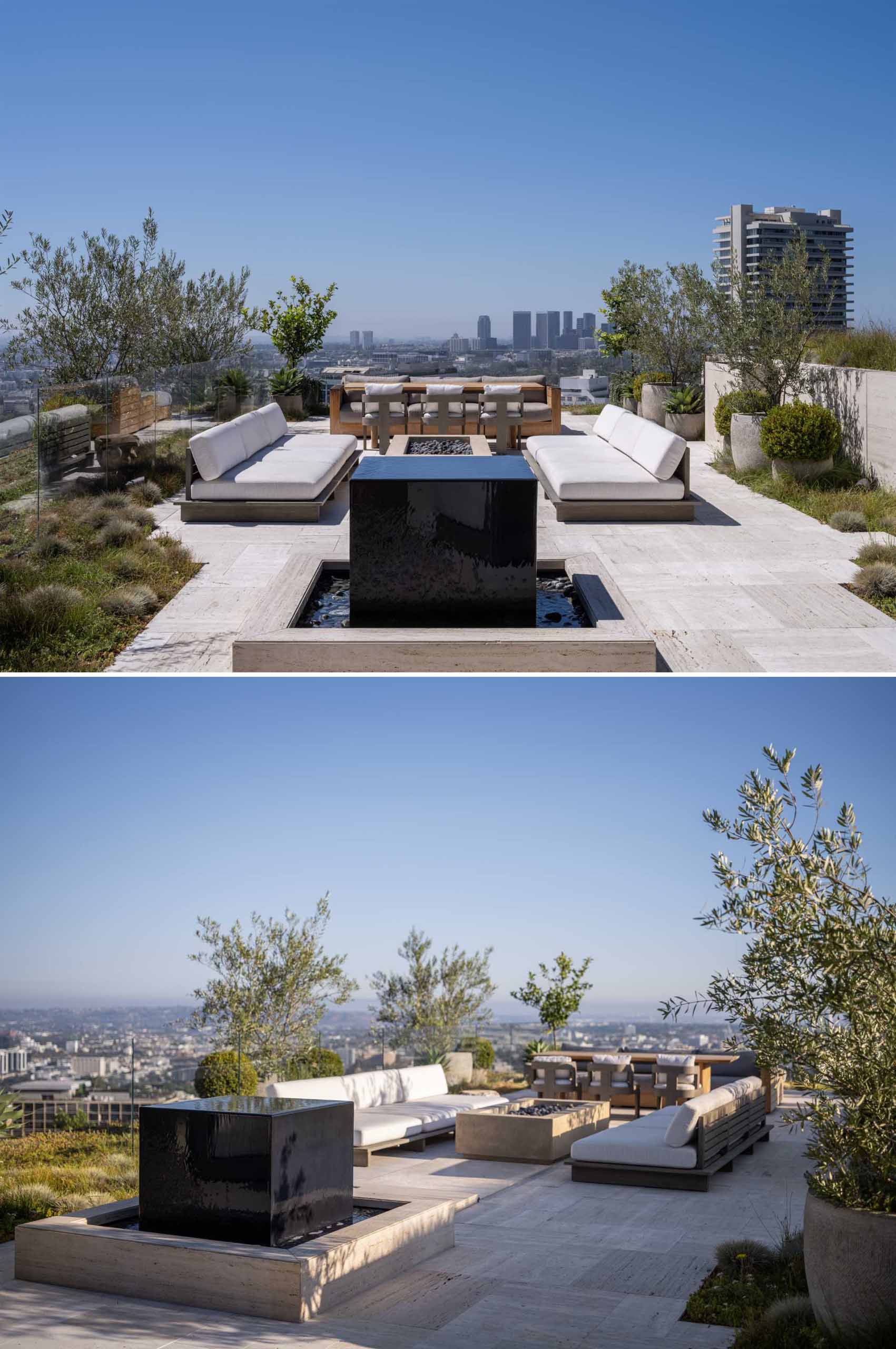 A modern house with a rooftop deck that includes a stone fountain, a lounge area with fireplace, and a dining area.