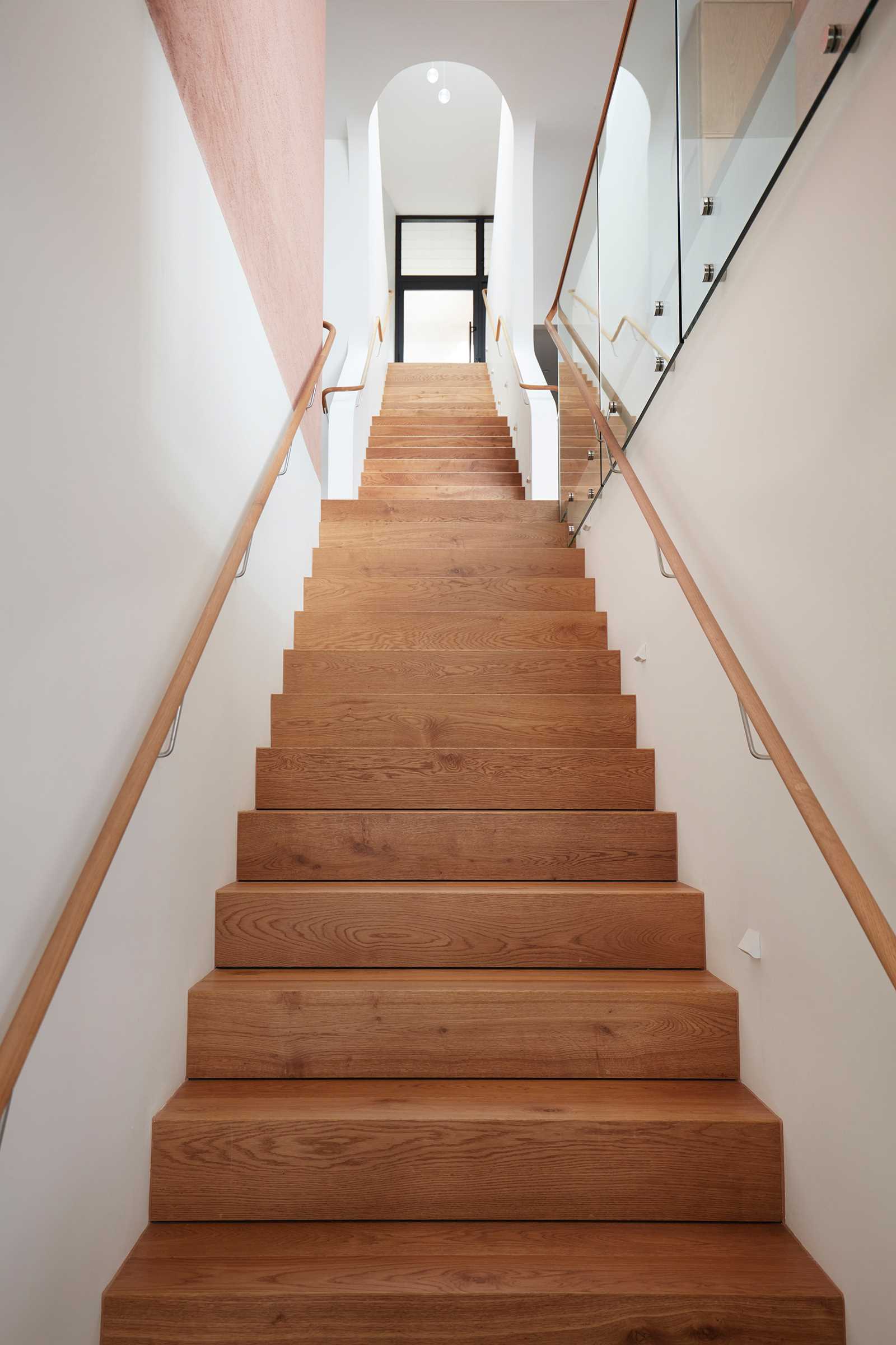 Inside this modern home, there's a linear staircase that cascades down to the different levels of the house.