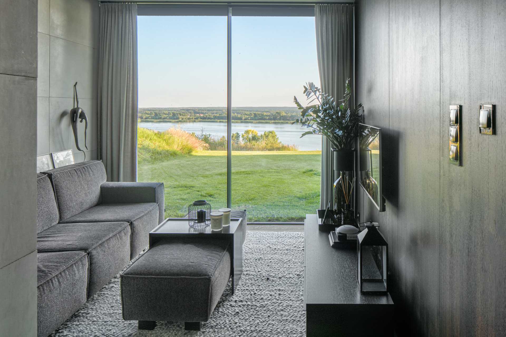 A modern tv room with sliding doors that open to the yard.