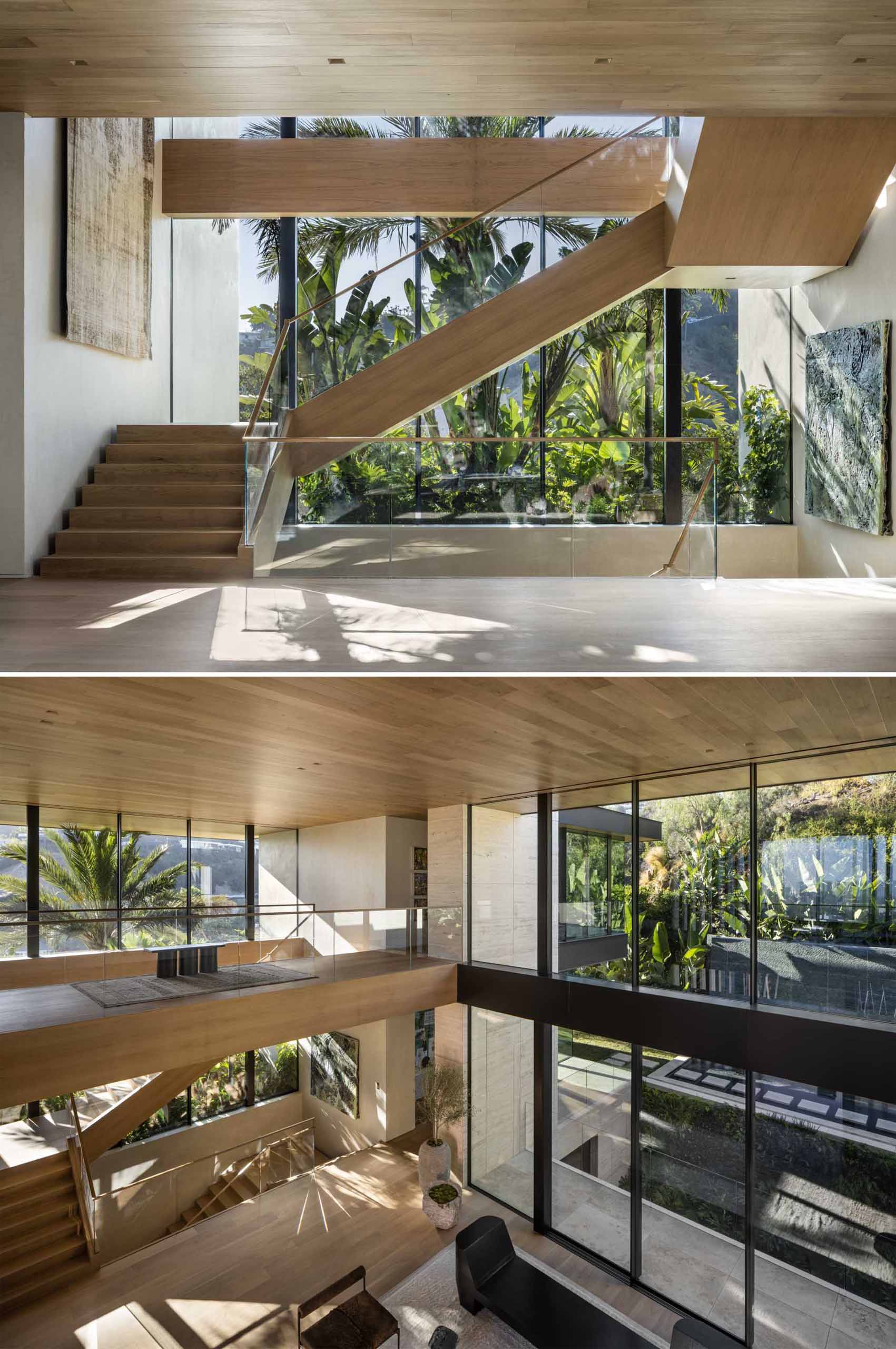 A modern home with wood stairs and double-height ceiling.