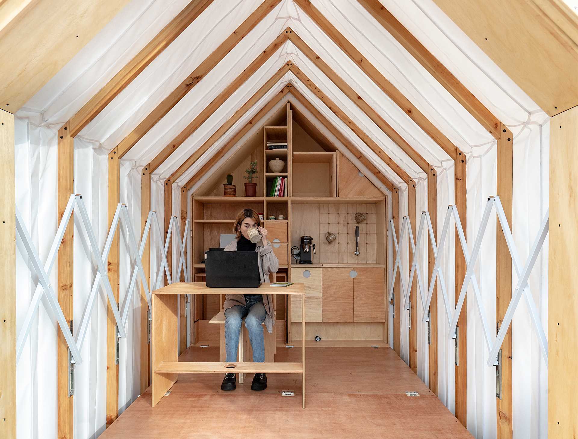 A small cabin-like room that expands when needed, and makes room for an office, or additional living space.