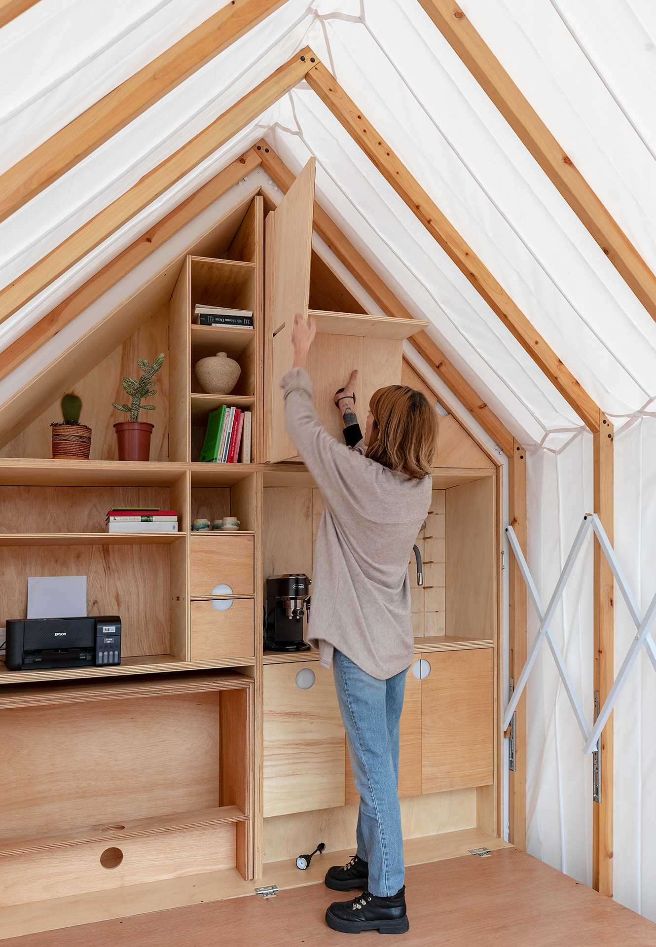 A small cabin-like room that expands when needed, and makes room for an office, or additional living space.