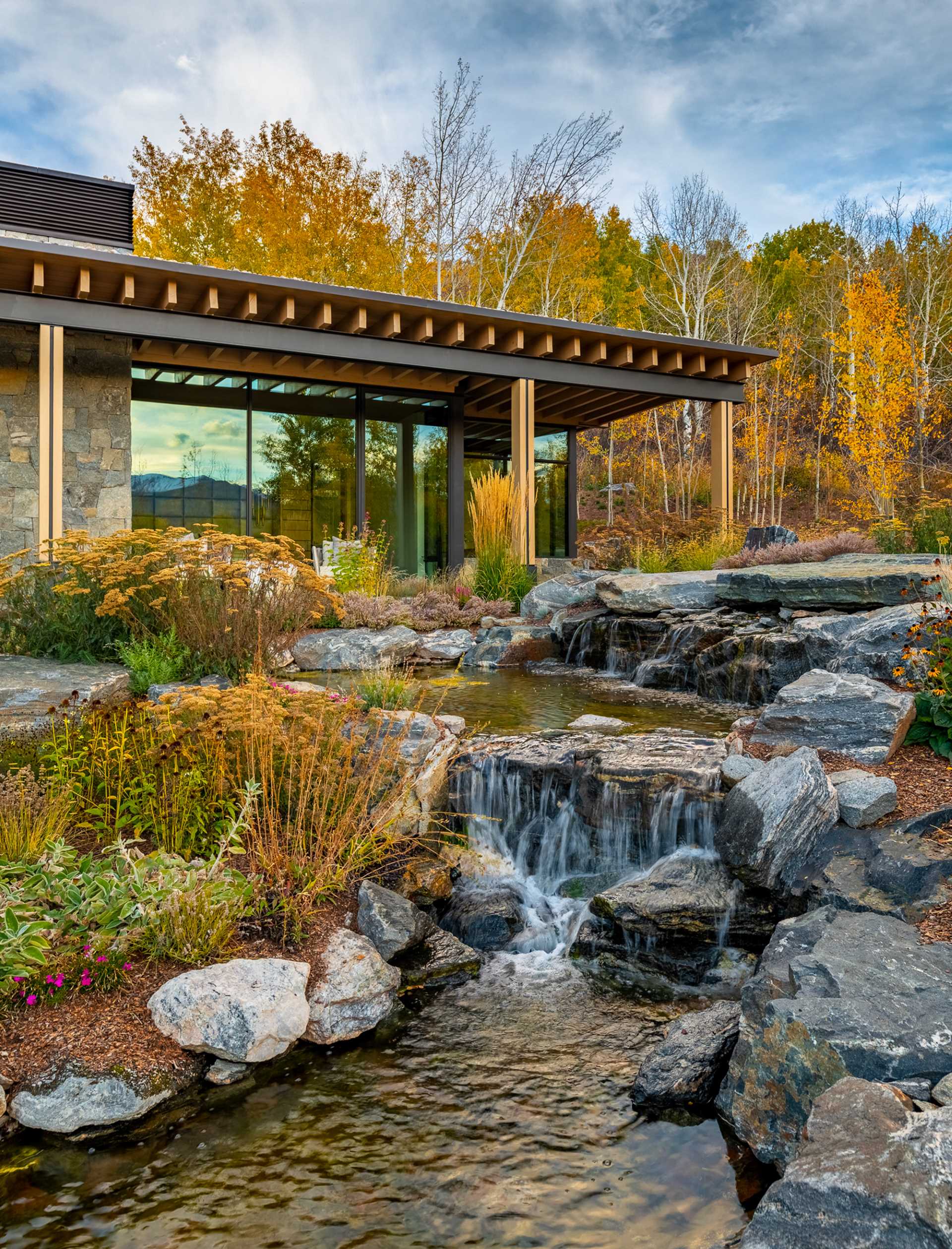 A contemporary mountain home clad in stone, wood, steel, and glass.