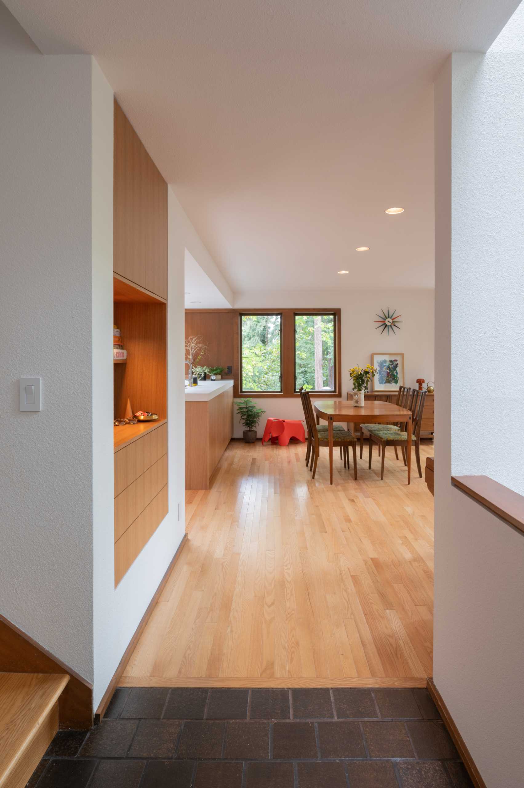 A contemporary home with an open dining area and built-in shelving.