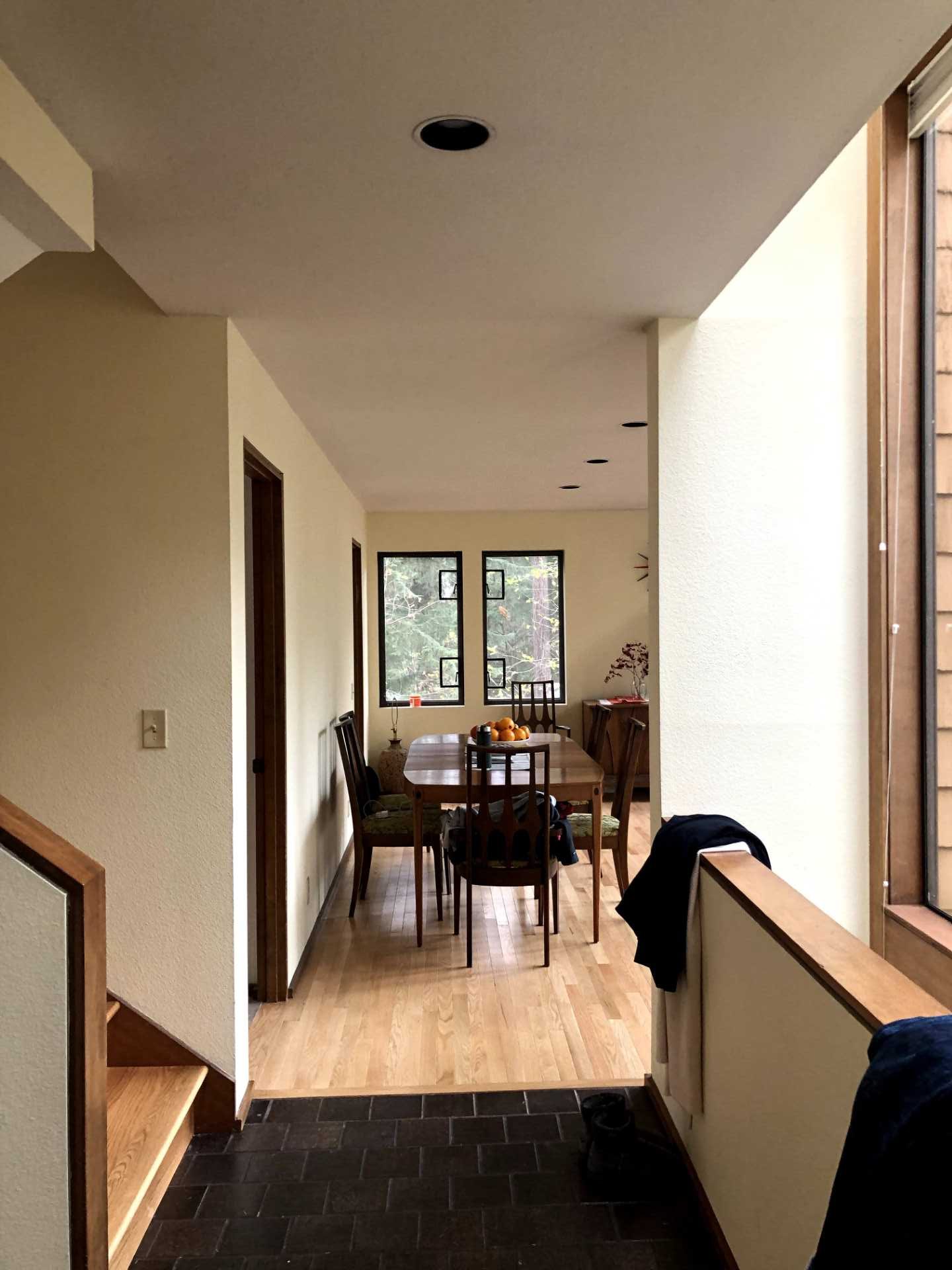 The before photo of a dining room that had access to the kitchen through a doorway.