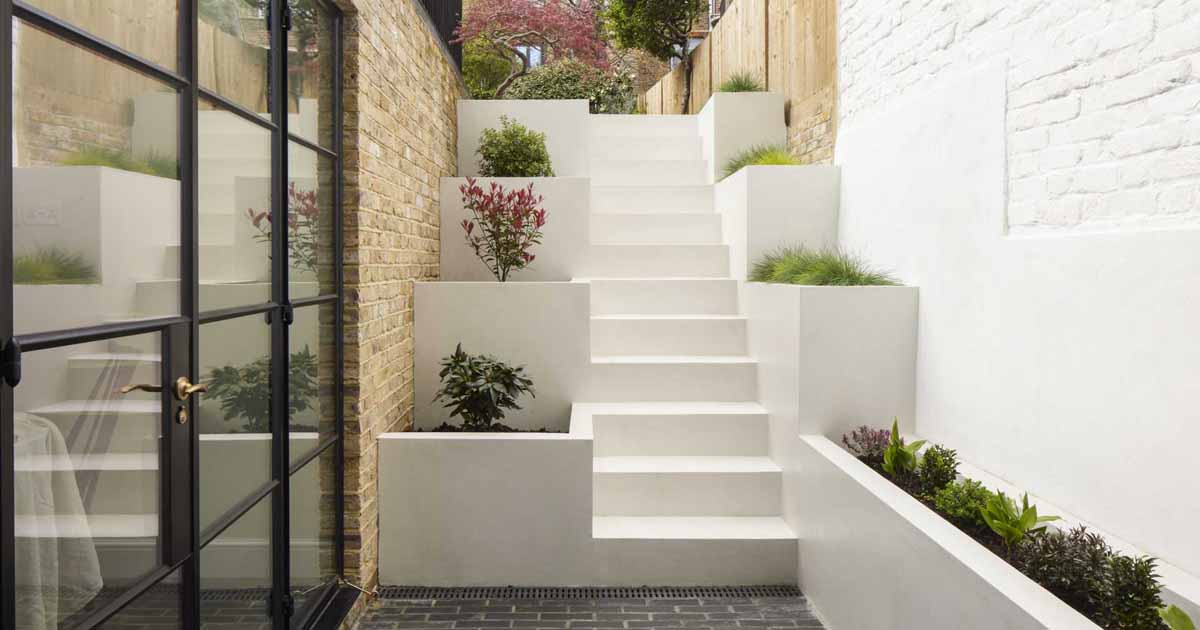 Stairs With Built-In Planters Lead To The Back Garden At This Home