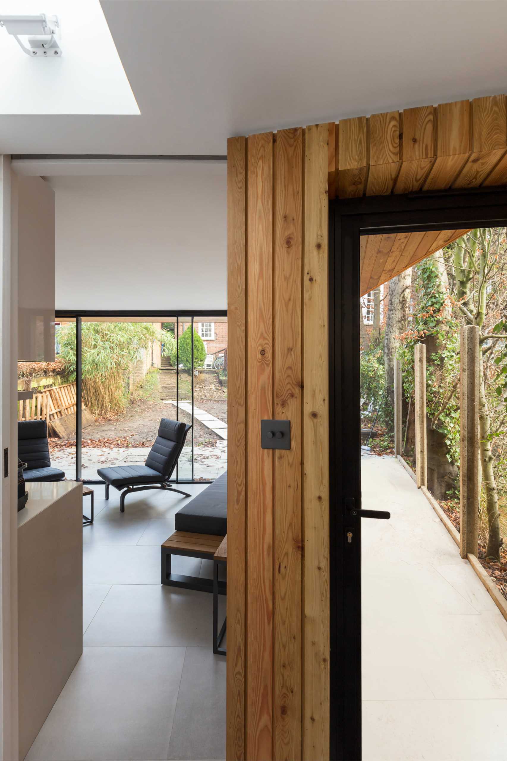 A modern backyard home office also includes a rock climbing gym.