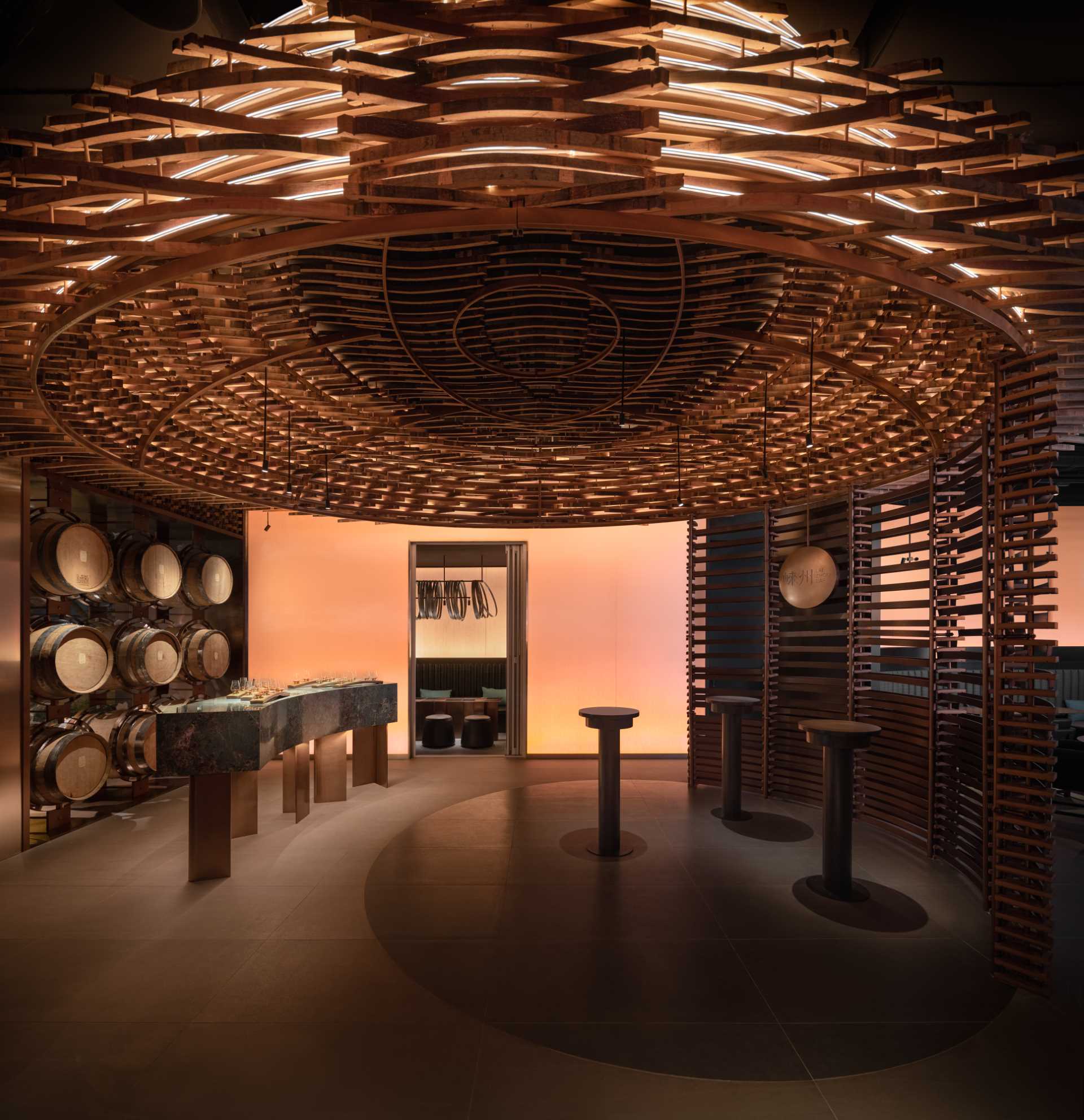 6000 pieces of discarded wooden whiskey barrels were recycled to make this modern bar.