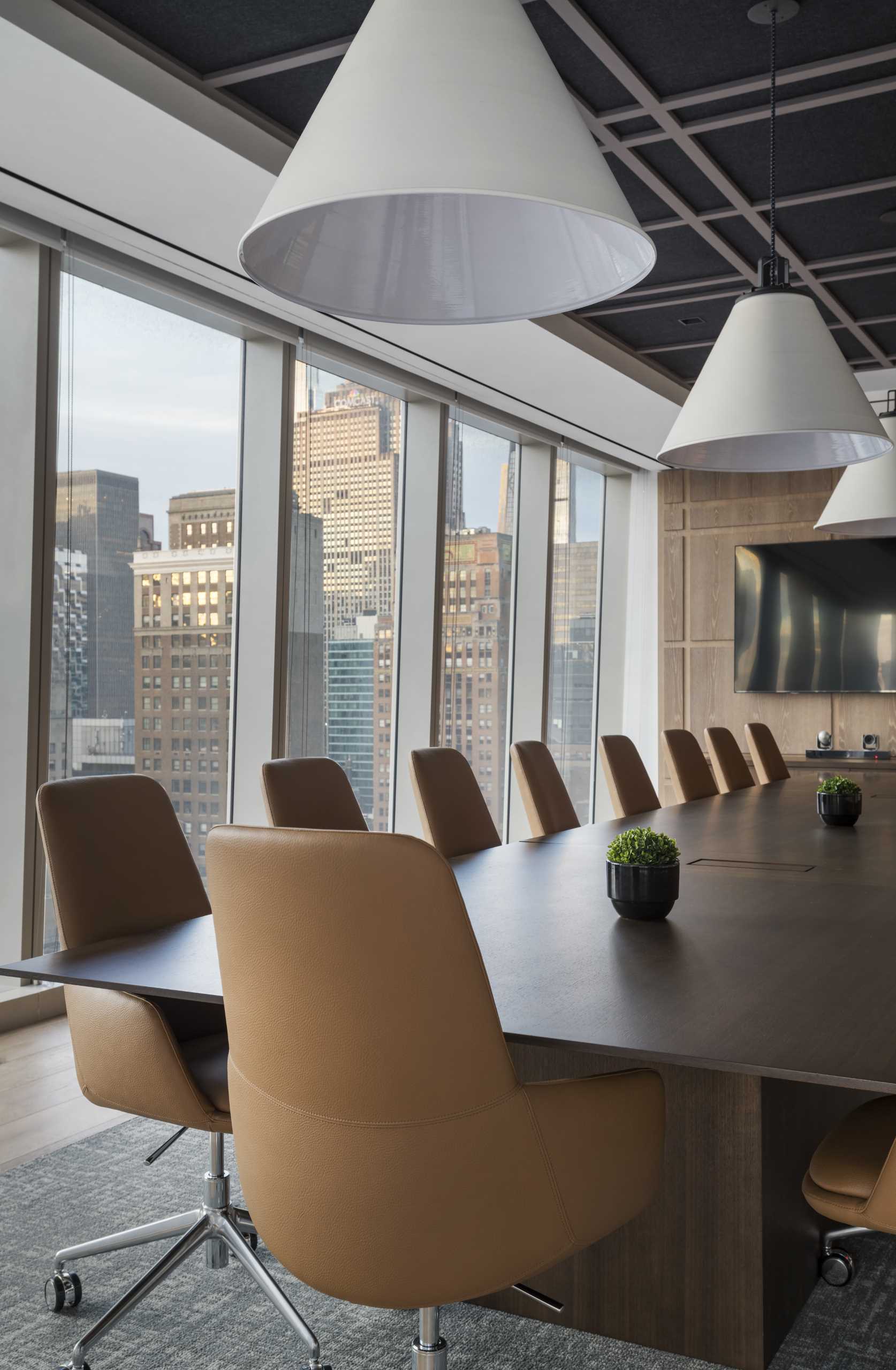 A modern meeting room with a plaid-inspired wood accent wall.