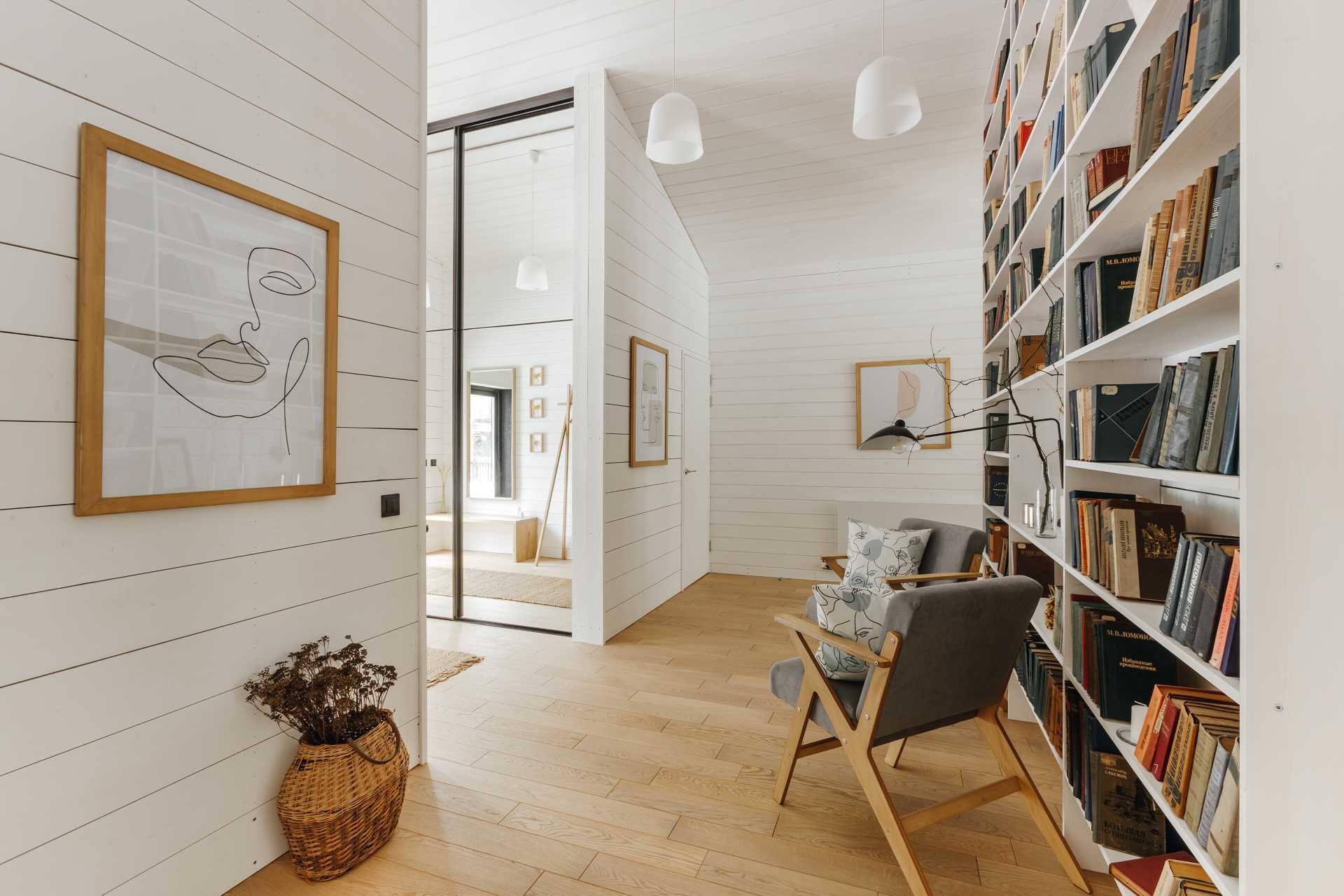 An entryway with a seating area and bookshelf.