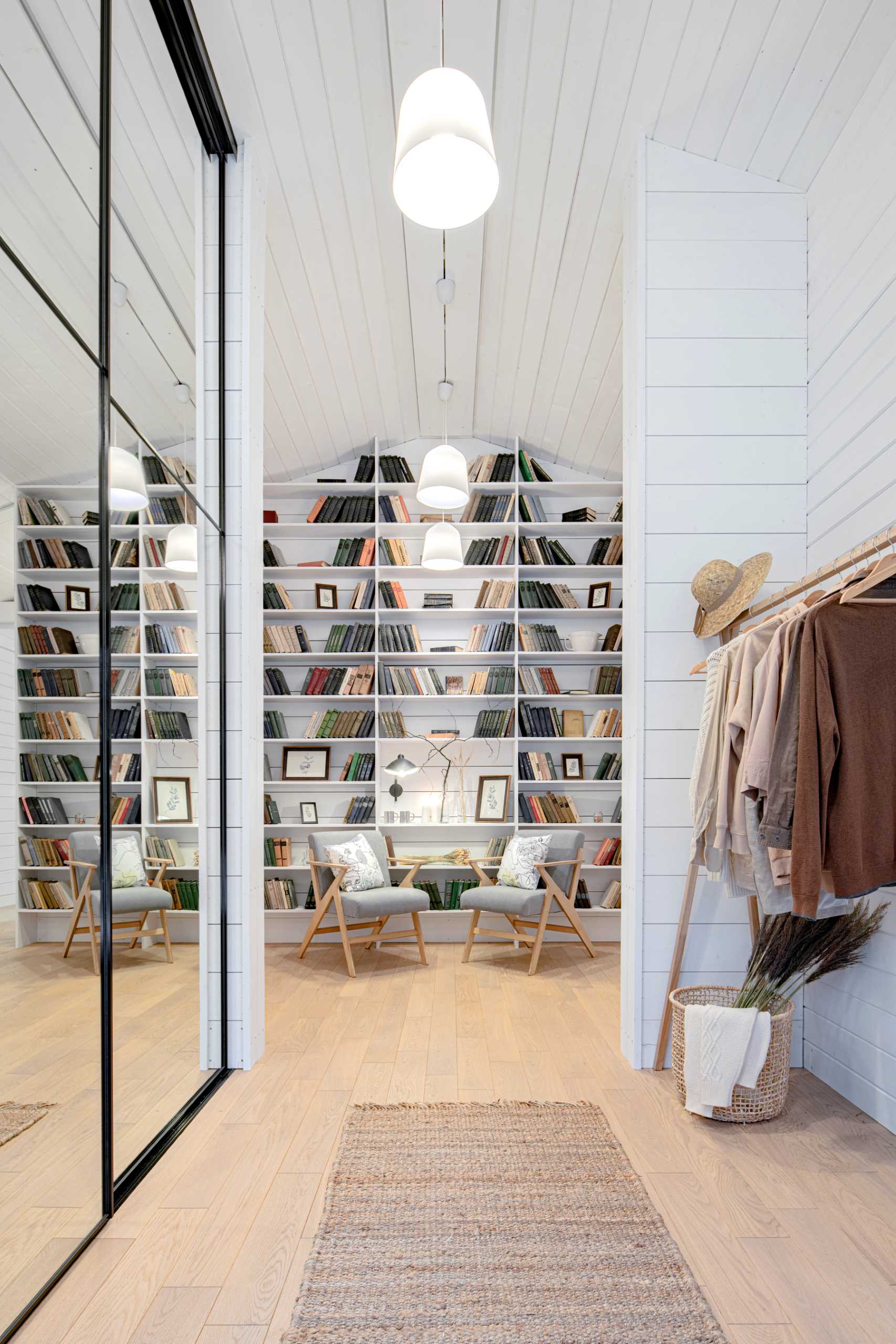 An entryway with a seating area and bookshelf.