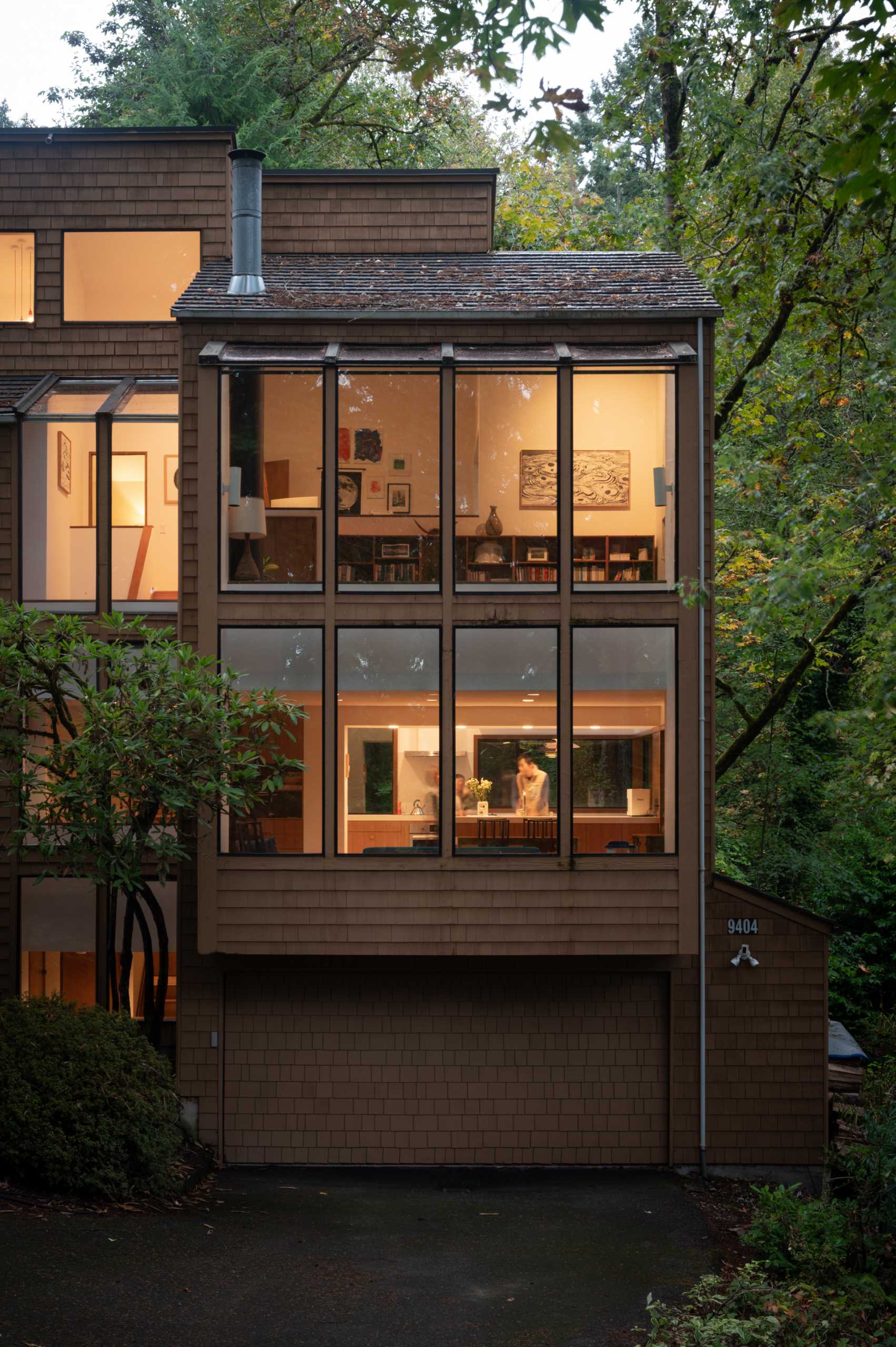 A 1970s home with a wood shingle and glass exterior.