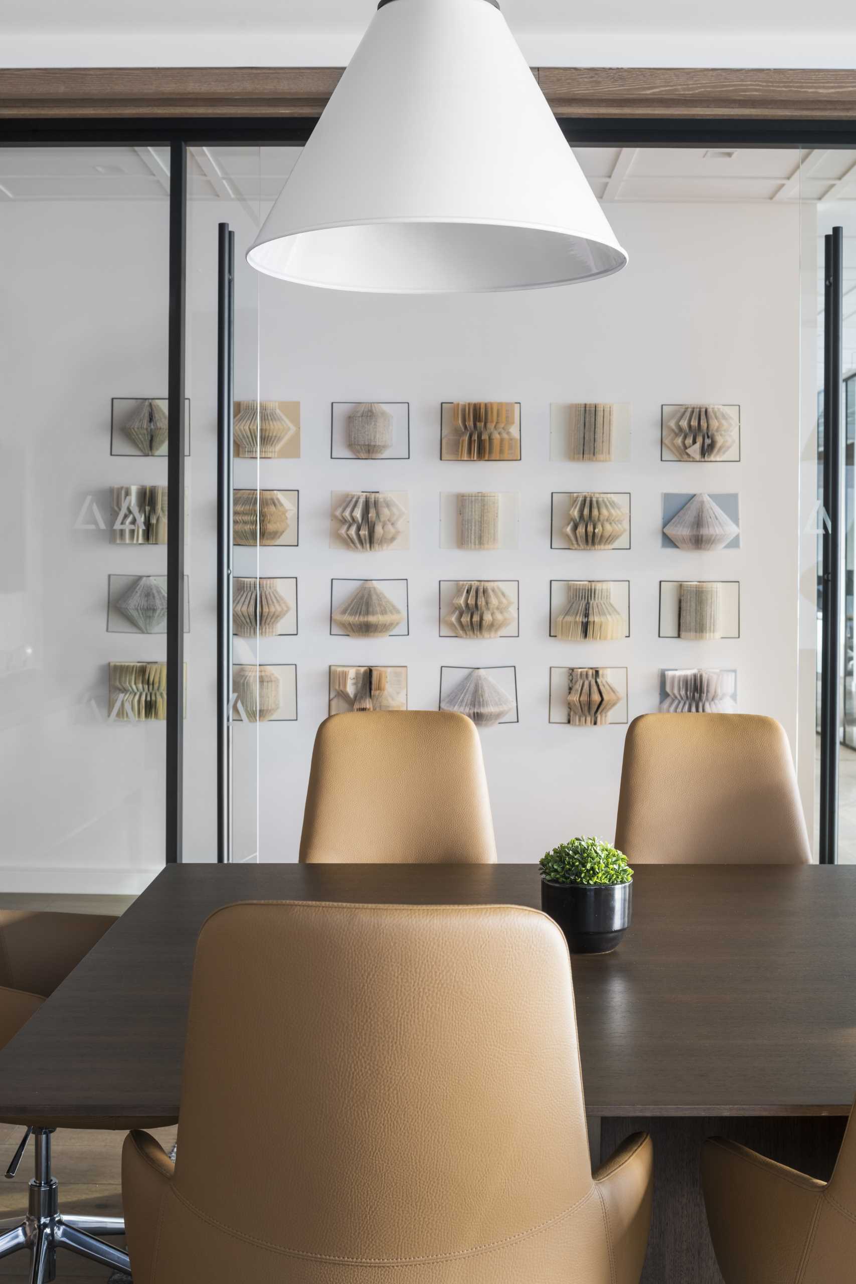 A modern workplace with folded book wall art.