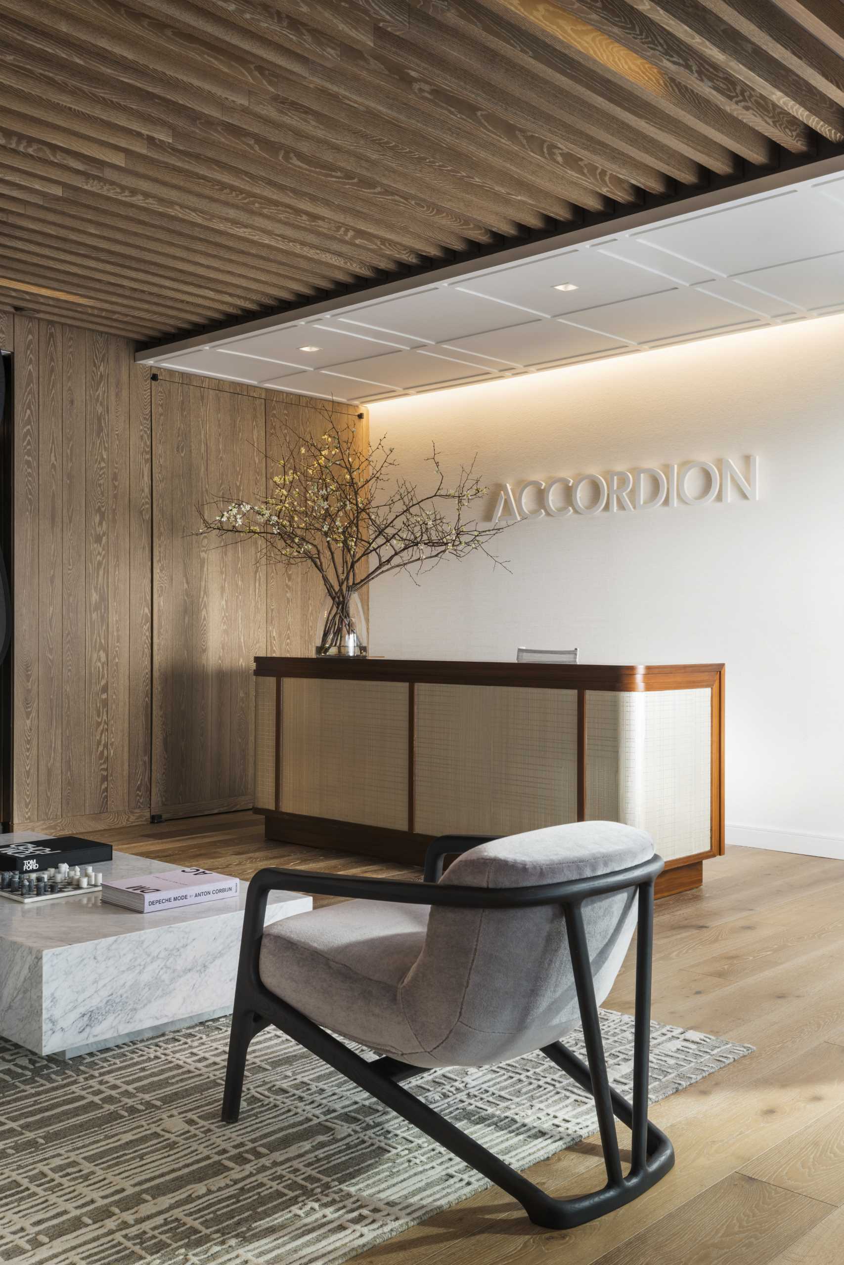A modern reception area with a warm wood and white palette.
