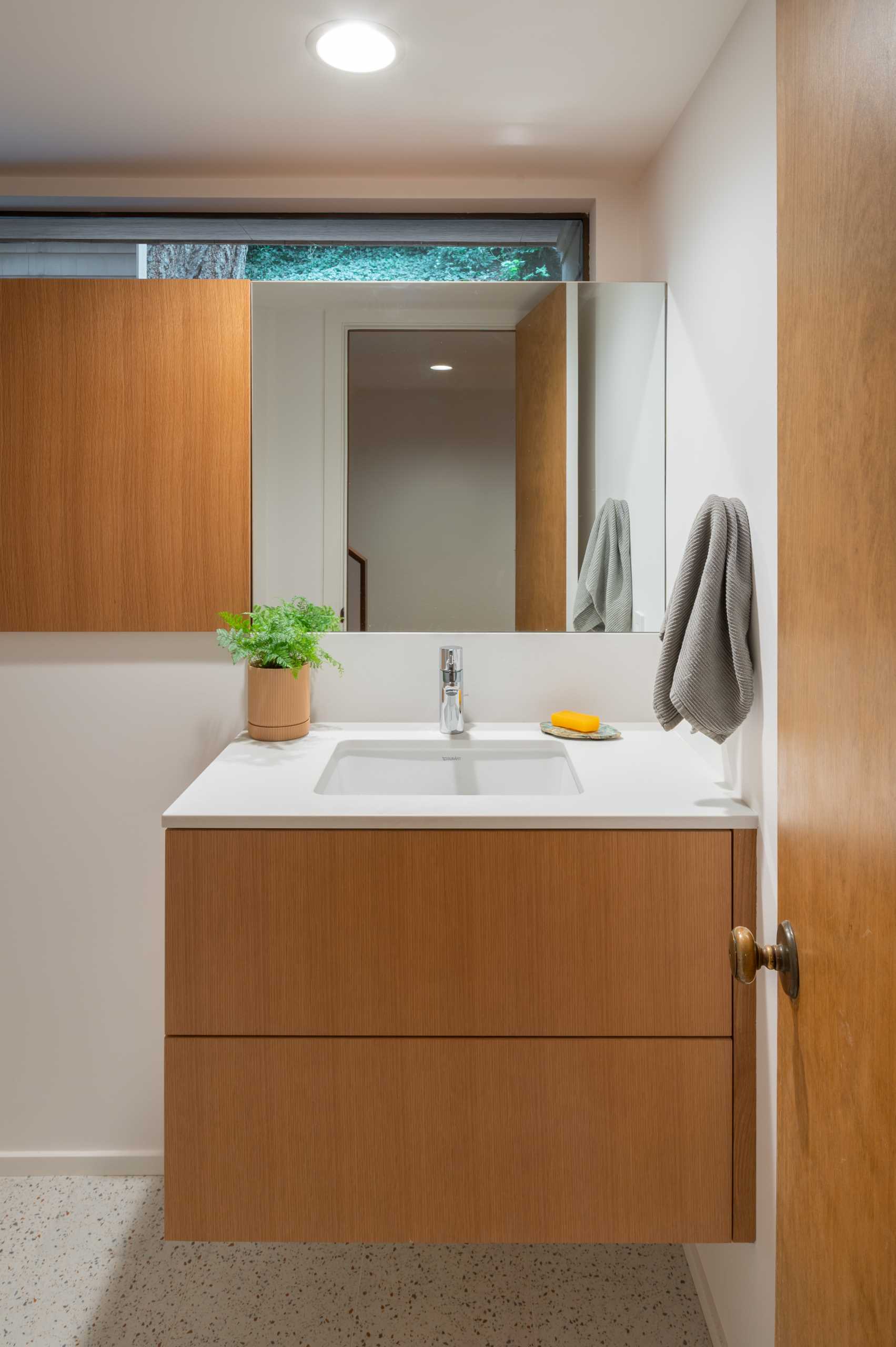 A modern powder room with a floating single vanity.