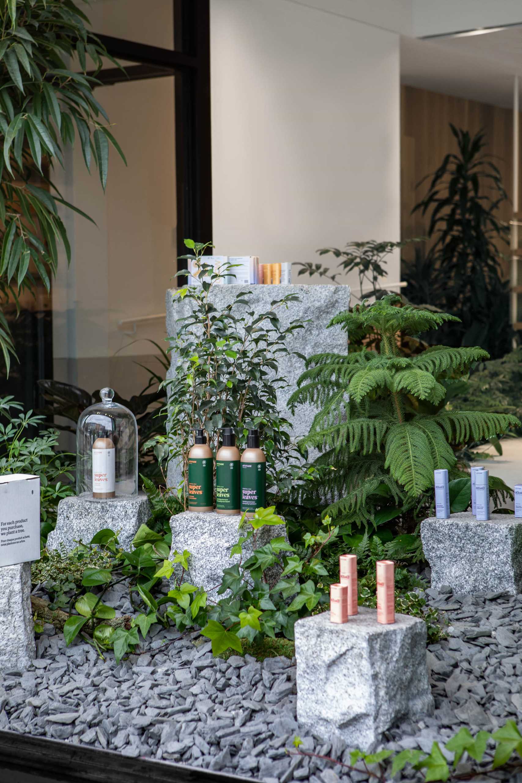 A modern retail store with built-in planters and stone accents throughout.