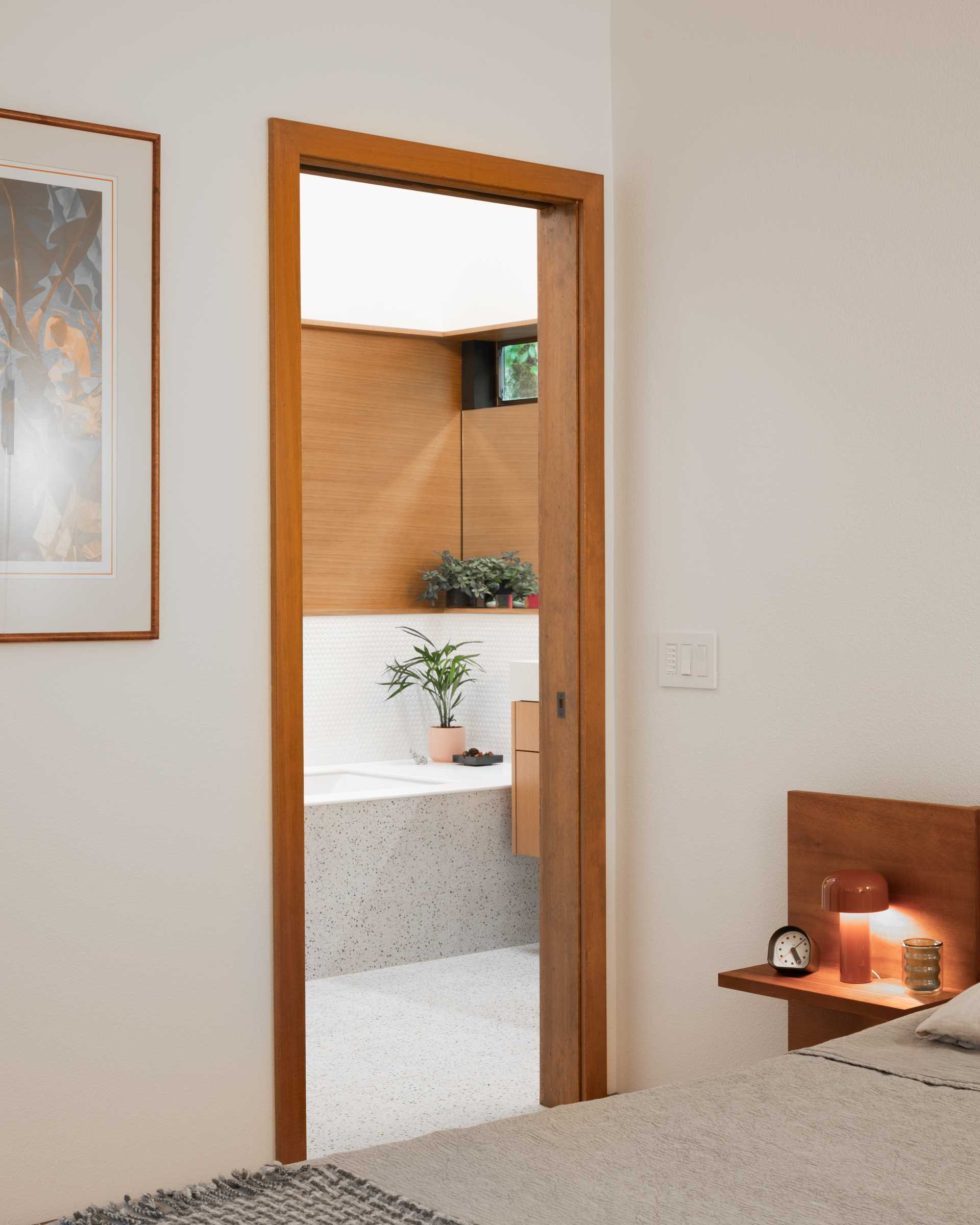 An updated bedroom with an en-suite bathroom.