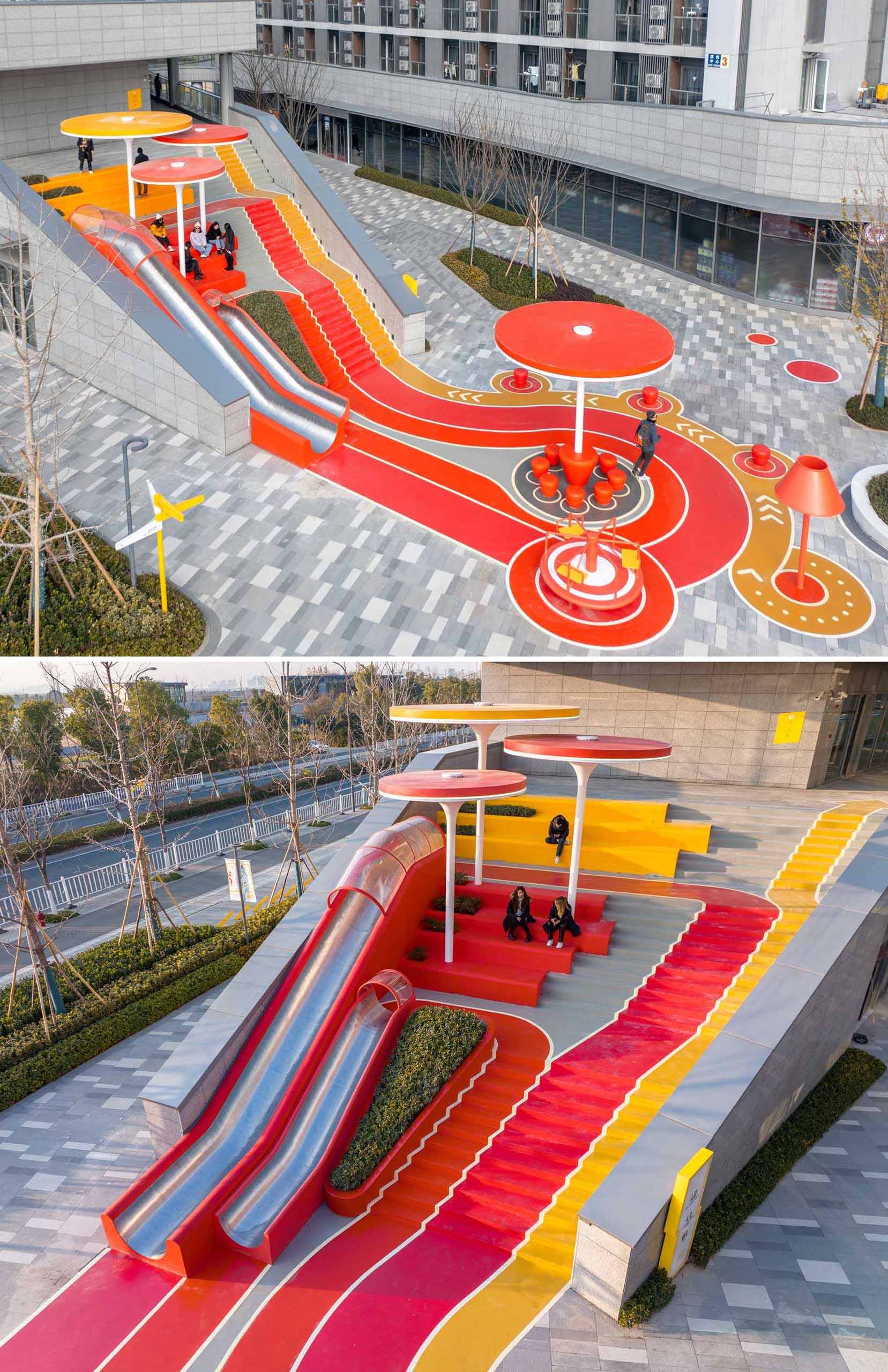 A modern and colorful landscaped park with slides, pathways, a merry-go-round, lounge seating, seesaw, shading structures, seating, swings, and an amphitheater.