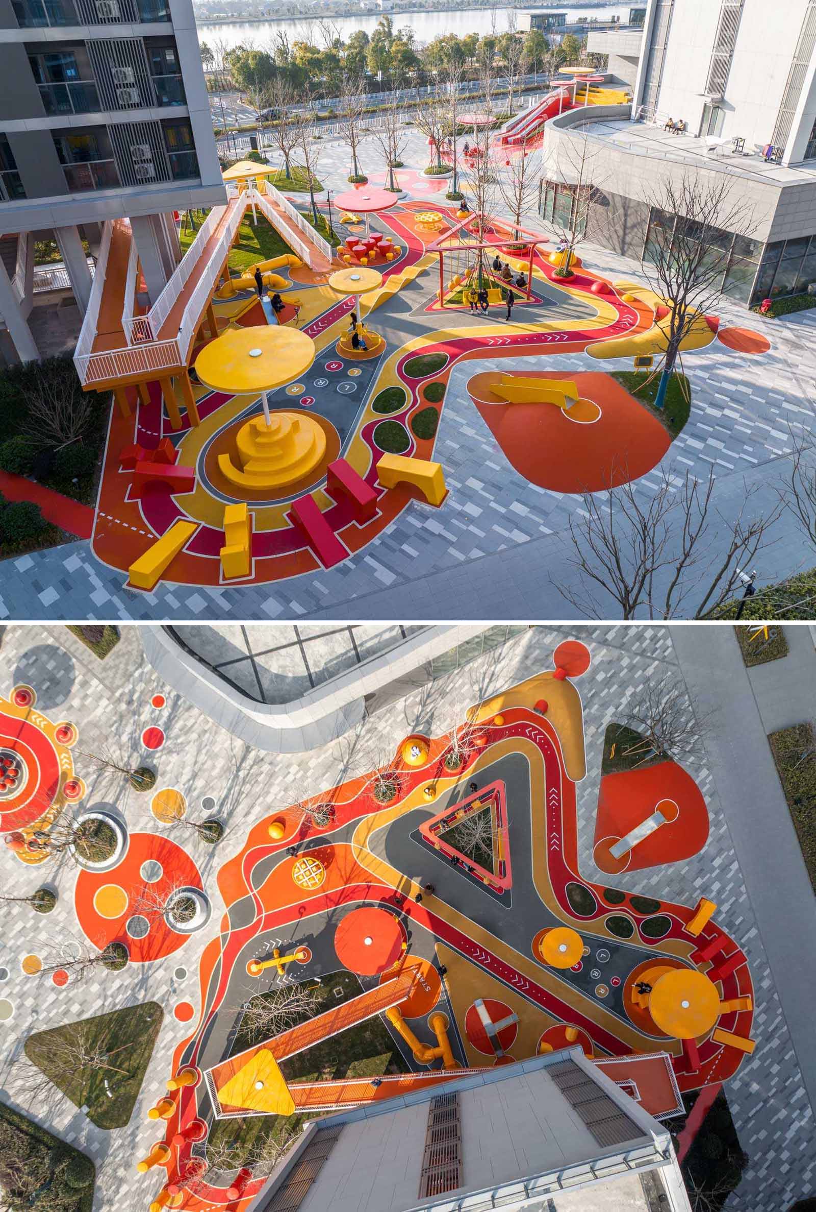 A modern and colorful landscaped park with slides, pathways, a merry-go-round, lounge seating, seesaw, shading structures, seating, swings, and an amphitheater.