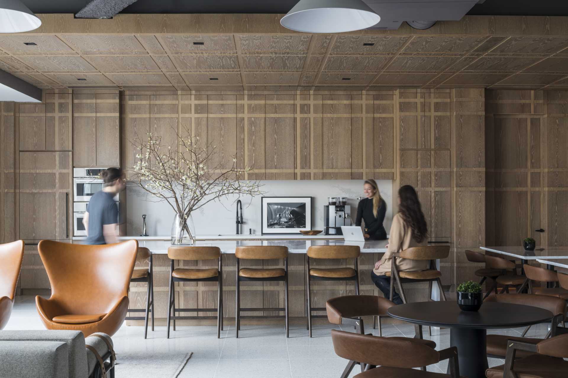This plaid-inspired wood-clad kitchen was conceived as a pochéd white oak bookend, with wood covering all cabinets, appliances, doors, and the island.