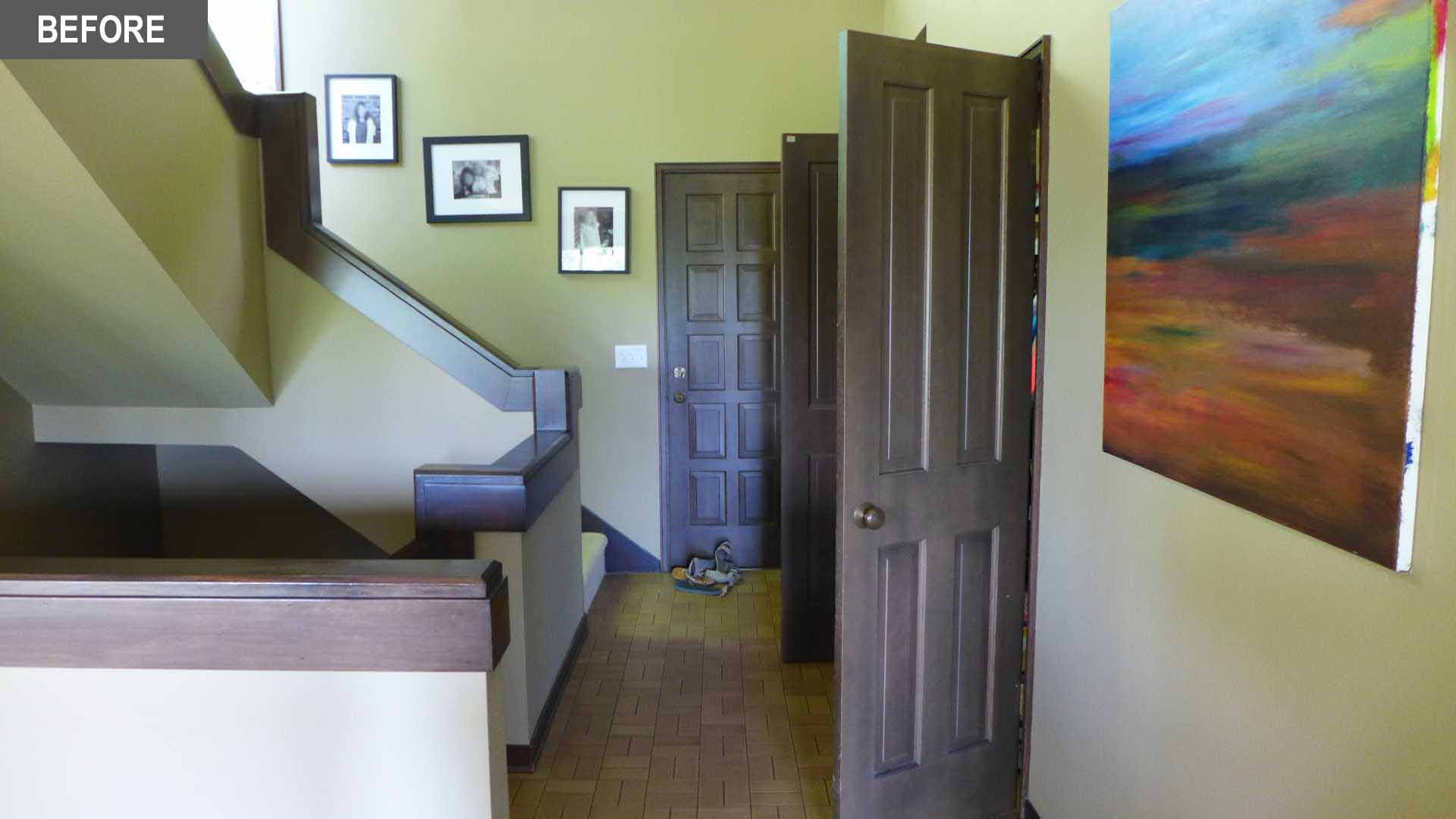BEFORE REMODEL - The original stairs featured green walls and dark wood accents.
