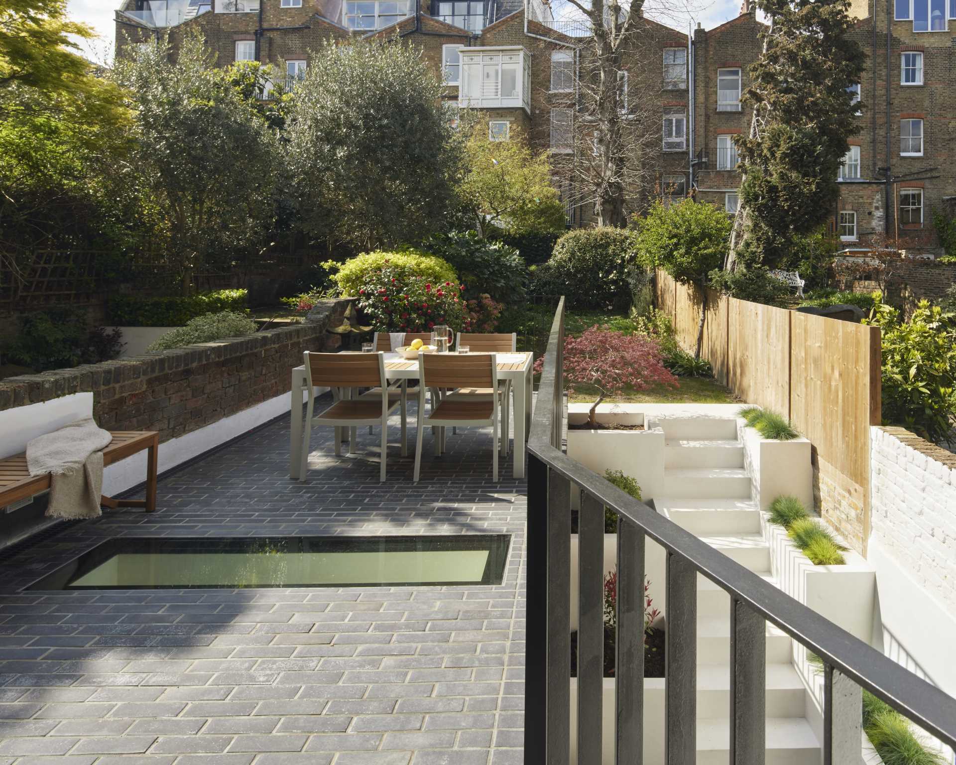 Outdoor stairs with built-in planters leads to a small patio and breakfast room.