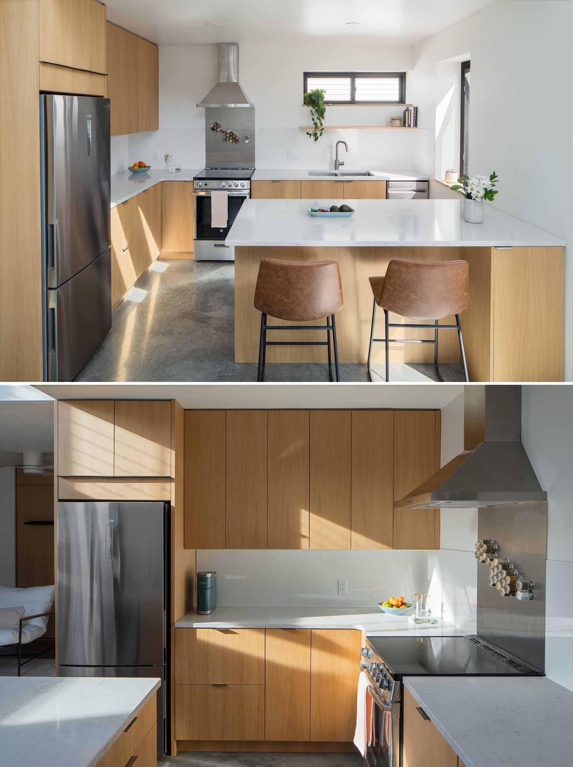 A modern kitchen with wood cabinetry and white countertops. Multiple windows allow natural light to fill the space.