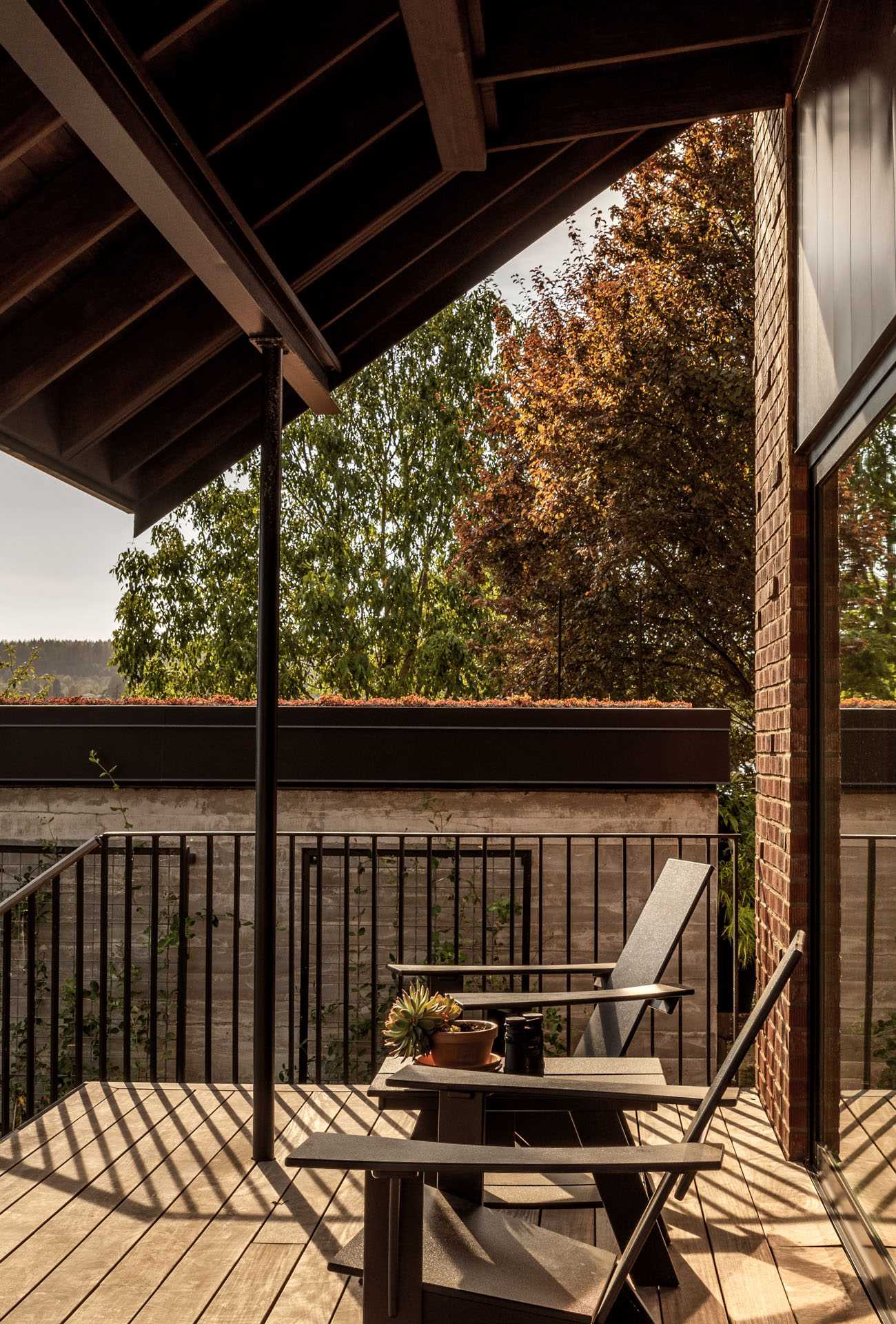 A covered porch with a view of a boathouse.