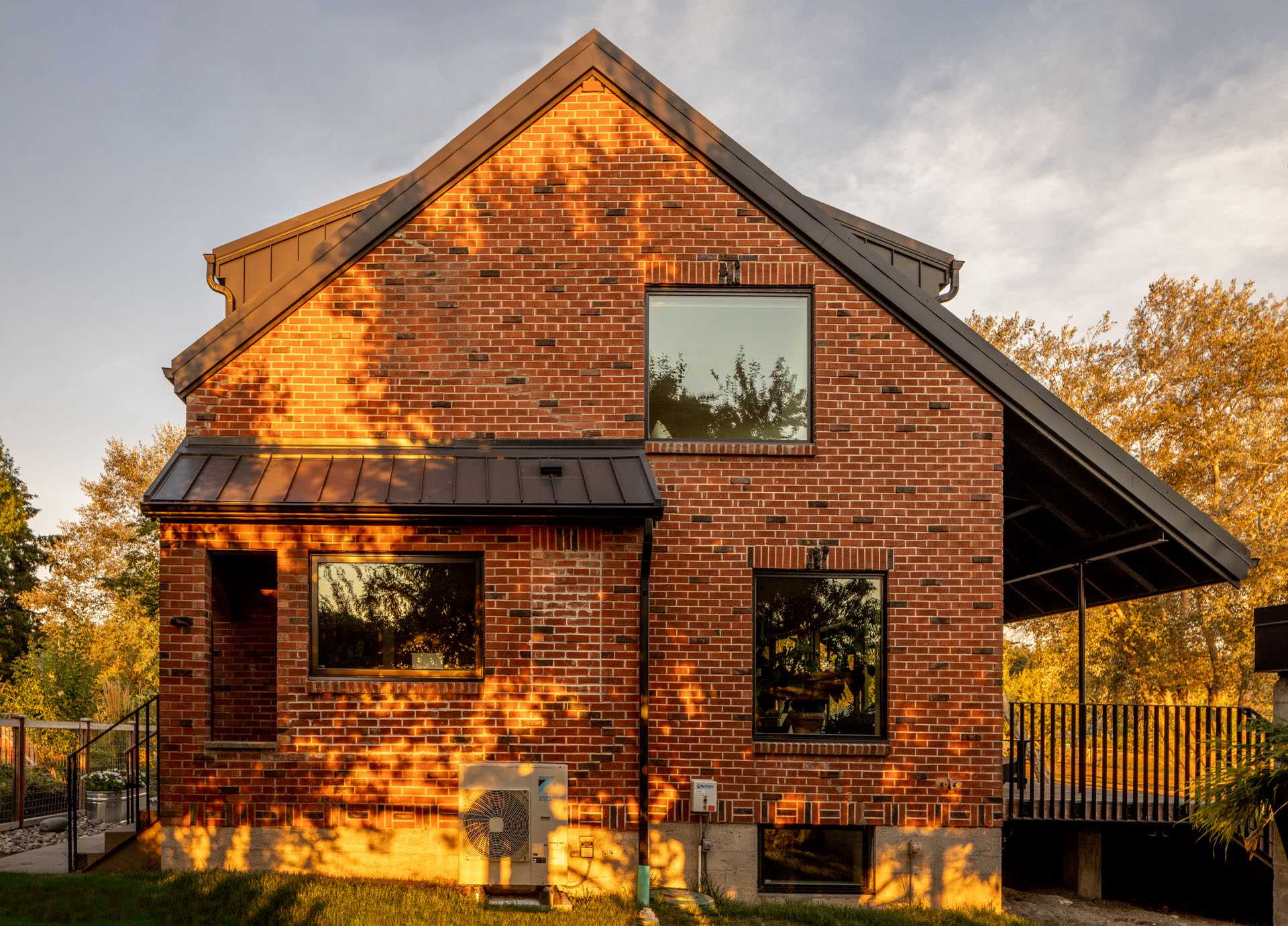 A remodeled brick home with new black-framed windows.