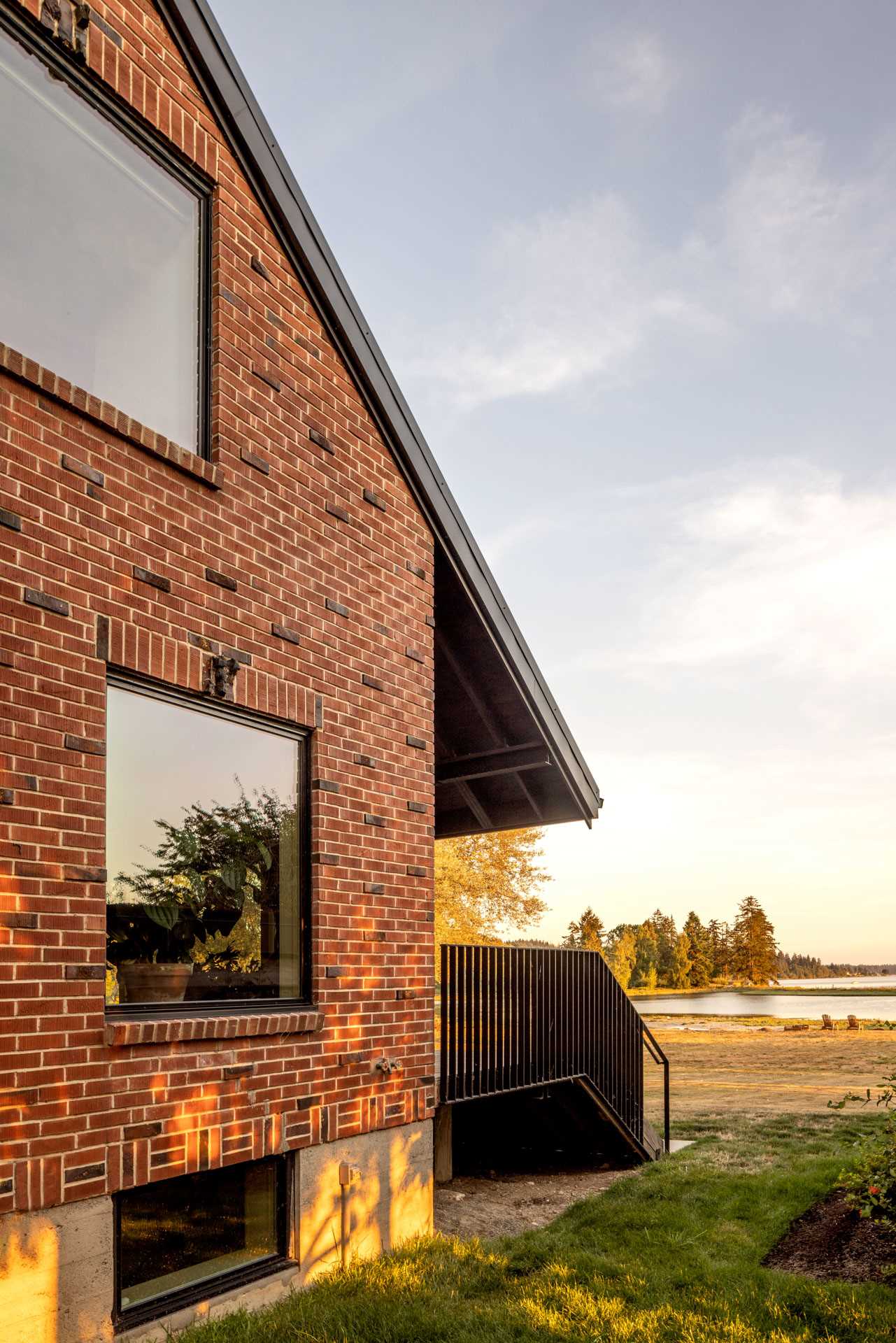 A remodeled brick home with new black-framed windows.