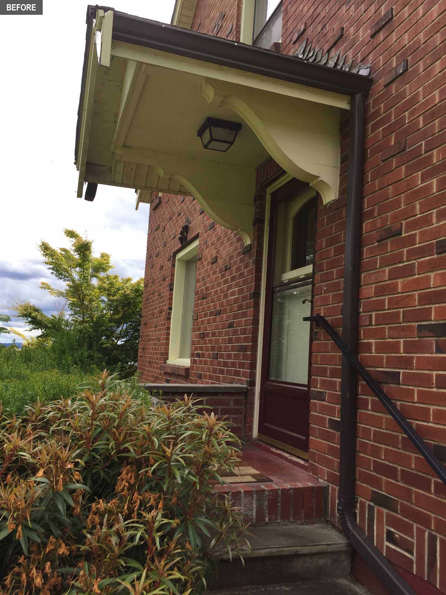 BEFORE - The front door of a brick farmhouse from the 1930's.