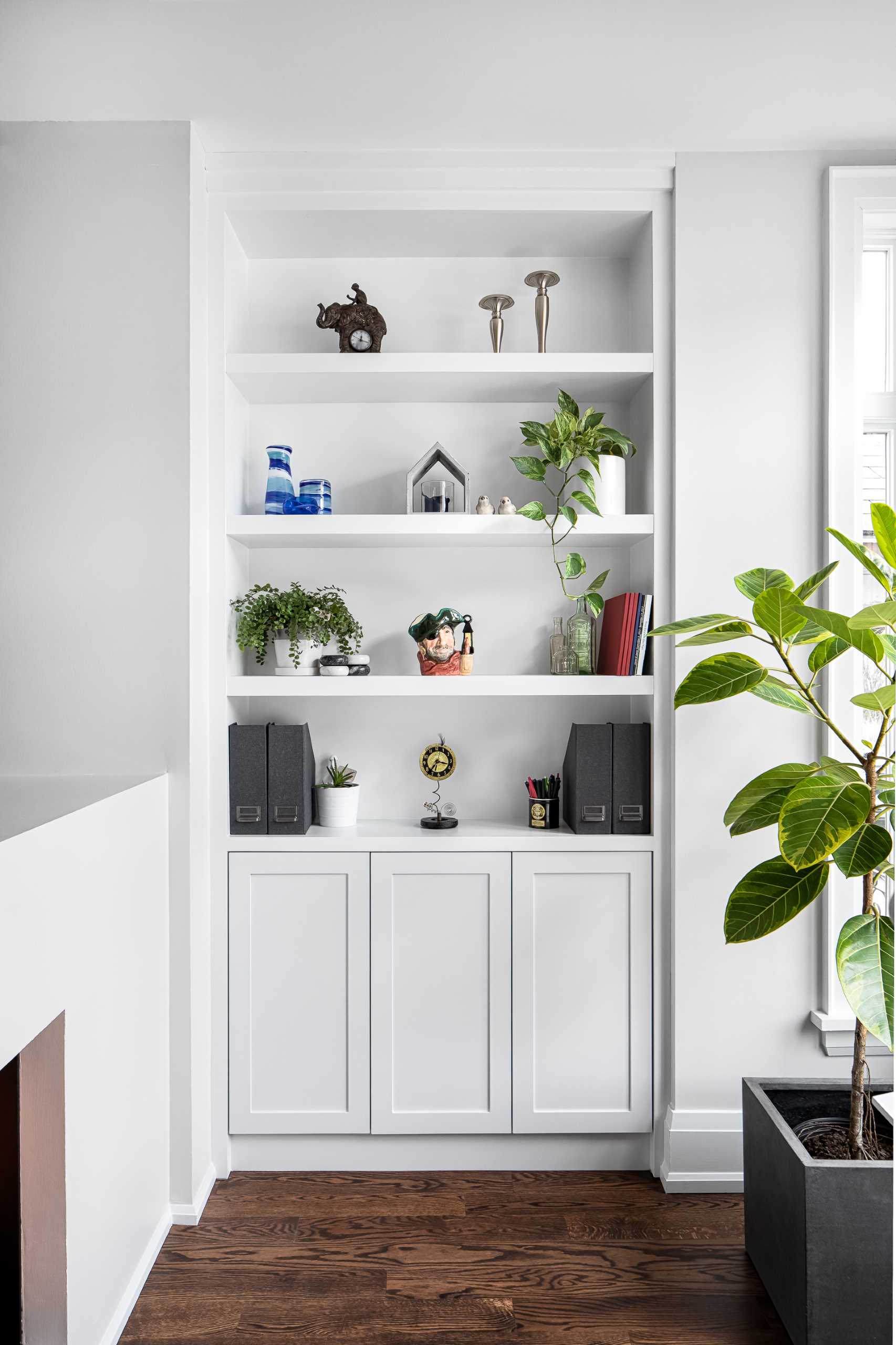 Custom design shelving niche and cabinetry provides a place for office accessories and decor.