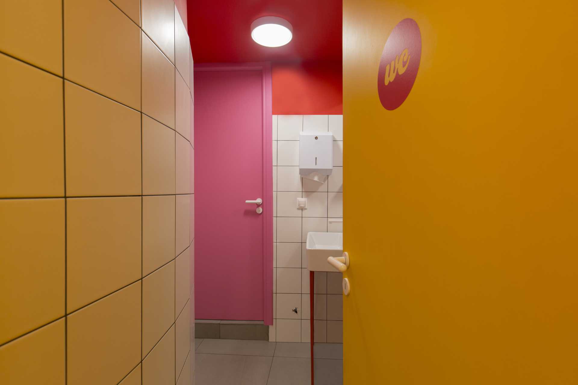 A boldly colored bathroom for a pasta shop/