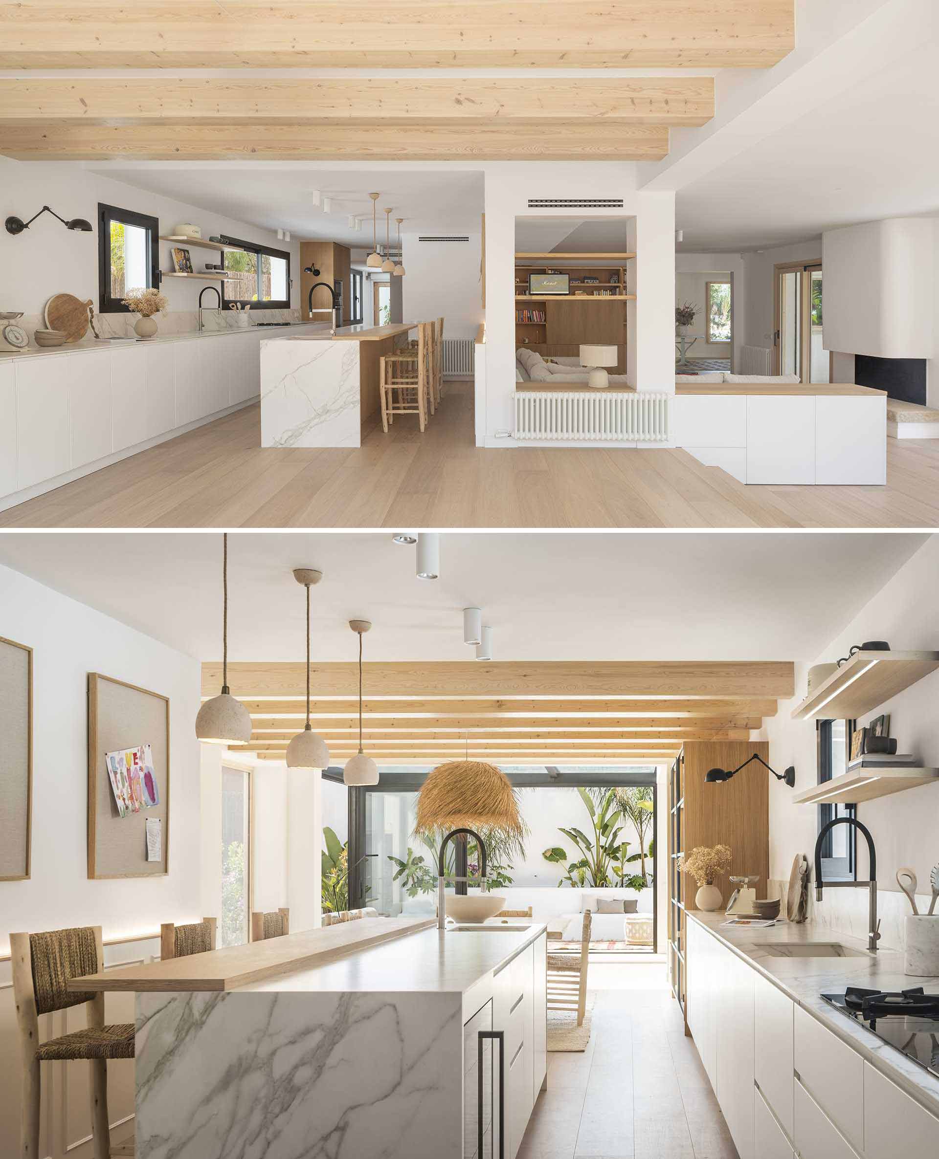 In this kitchen, lower white cabinets line the wall, while an island provides a place for seating.