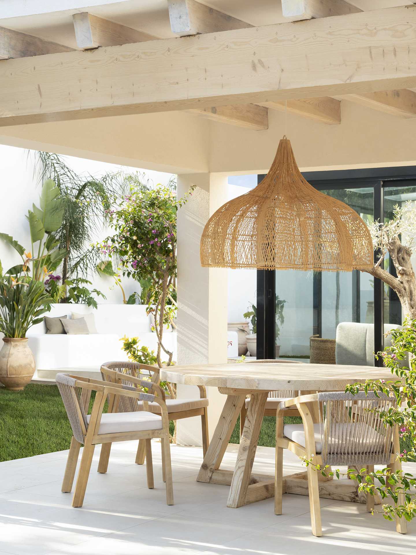 A covered patio with an outdoor dining and lounge area.