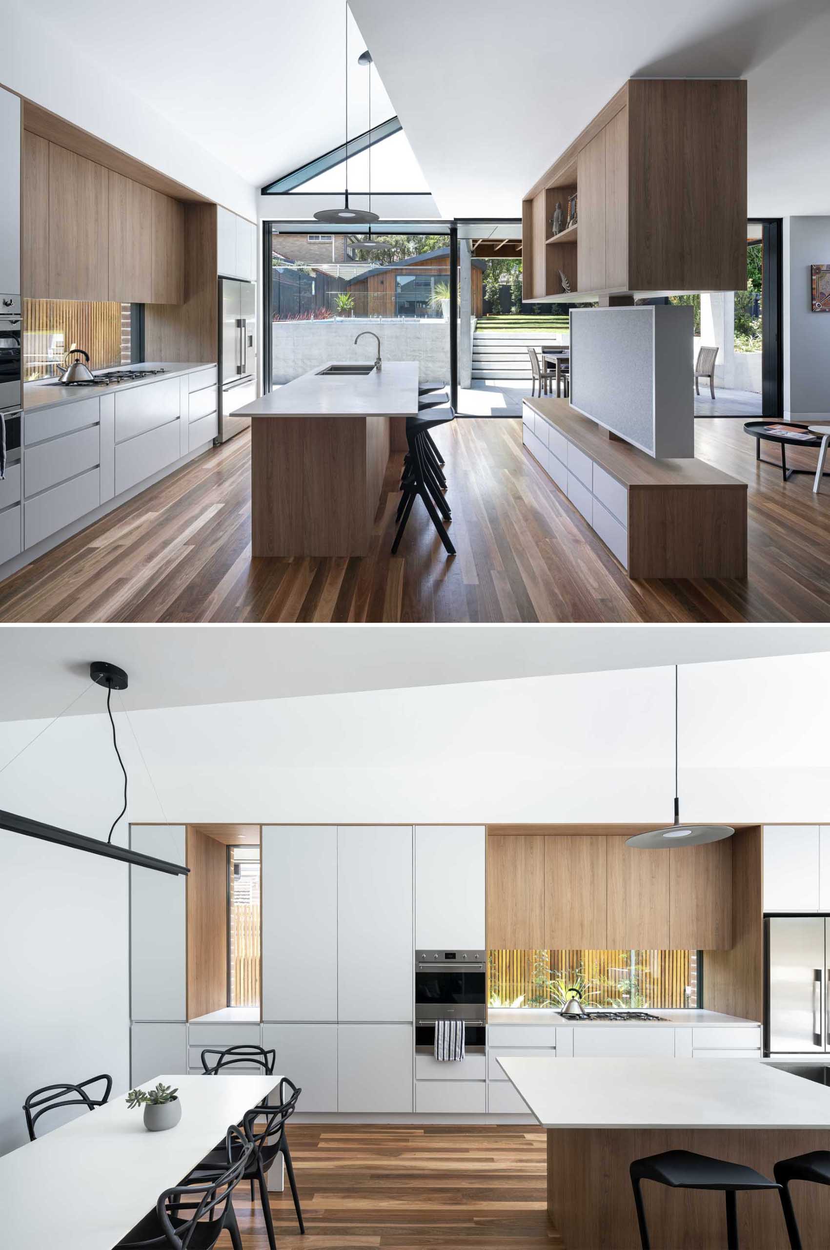 In this modern kitchen, wood and white cabinetry complement the wood floor and soften the concrete elements found outside.