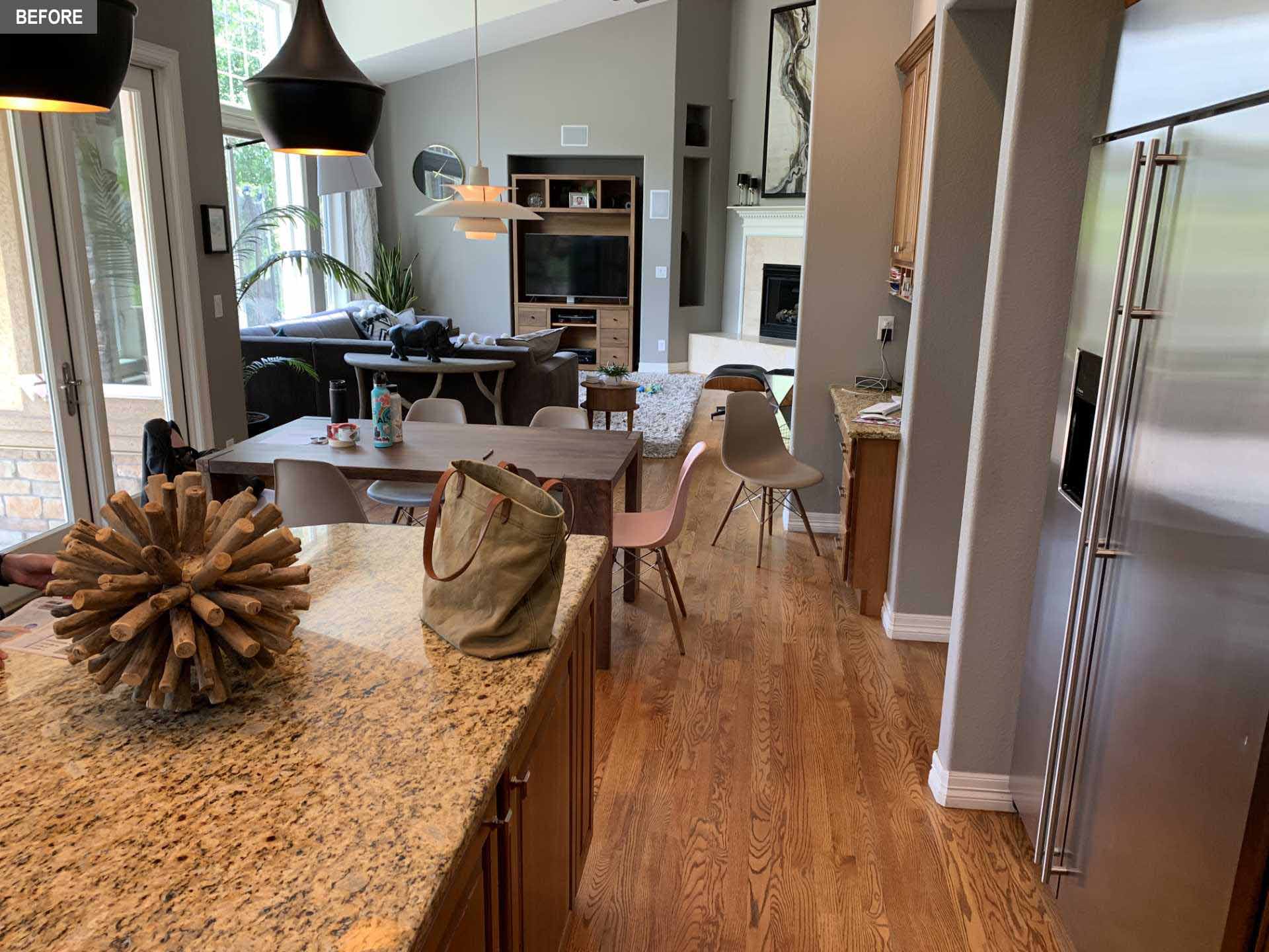 BEFORE - A dated kitchen includes builders-grade kitchen with wood cabinets that made the space quite dark.