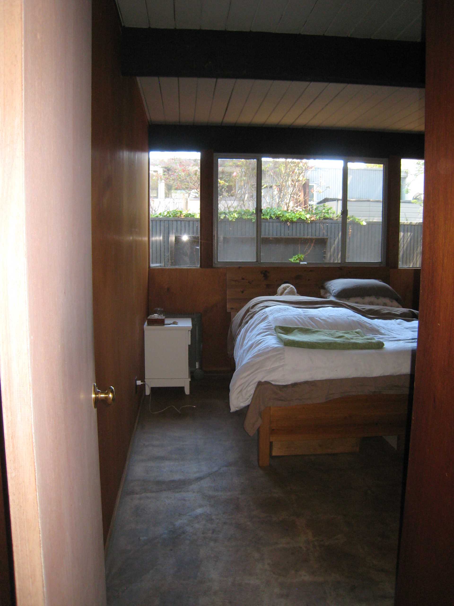 'Before' bedroom photo of an Eichler home.