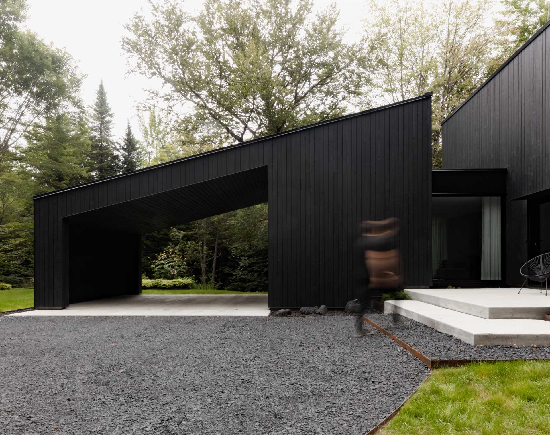 This modern home has a black wood exterior, with black window frames providing consistency to the design.