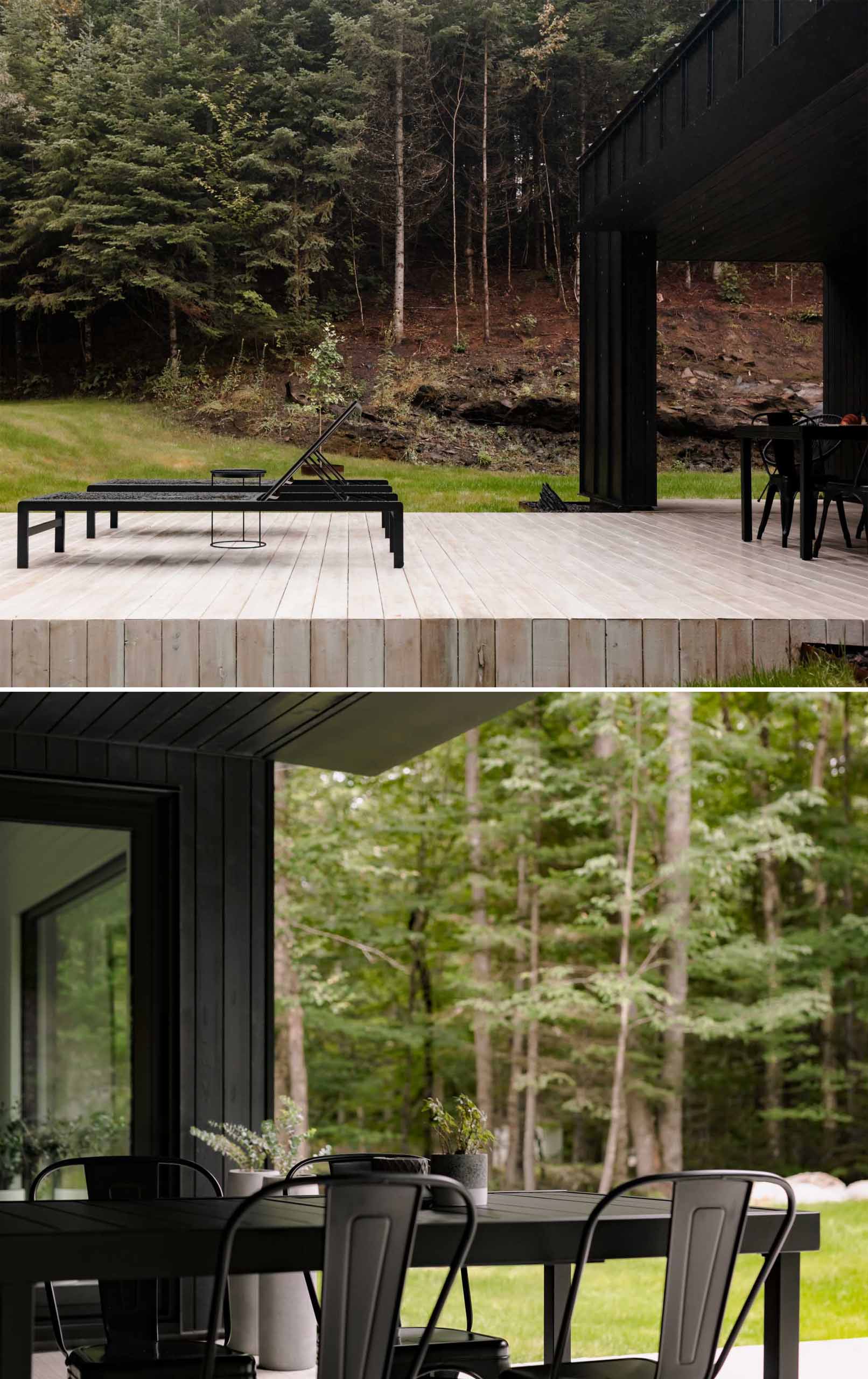 A modern black home with a light wood deck.