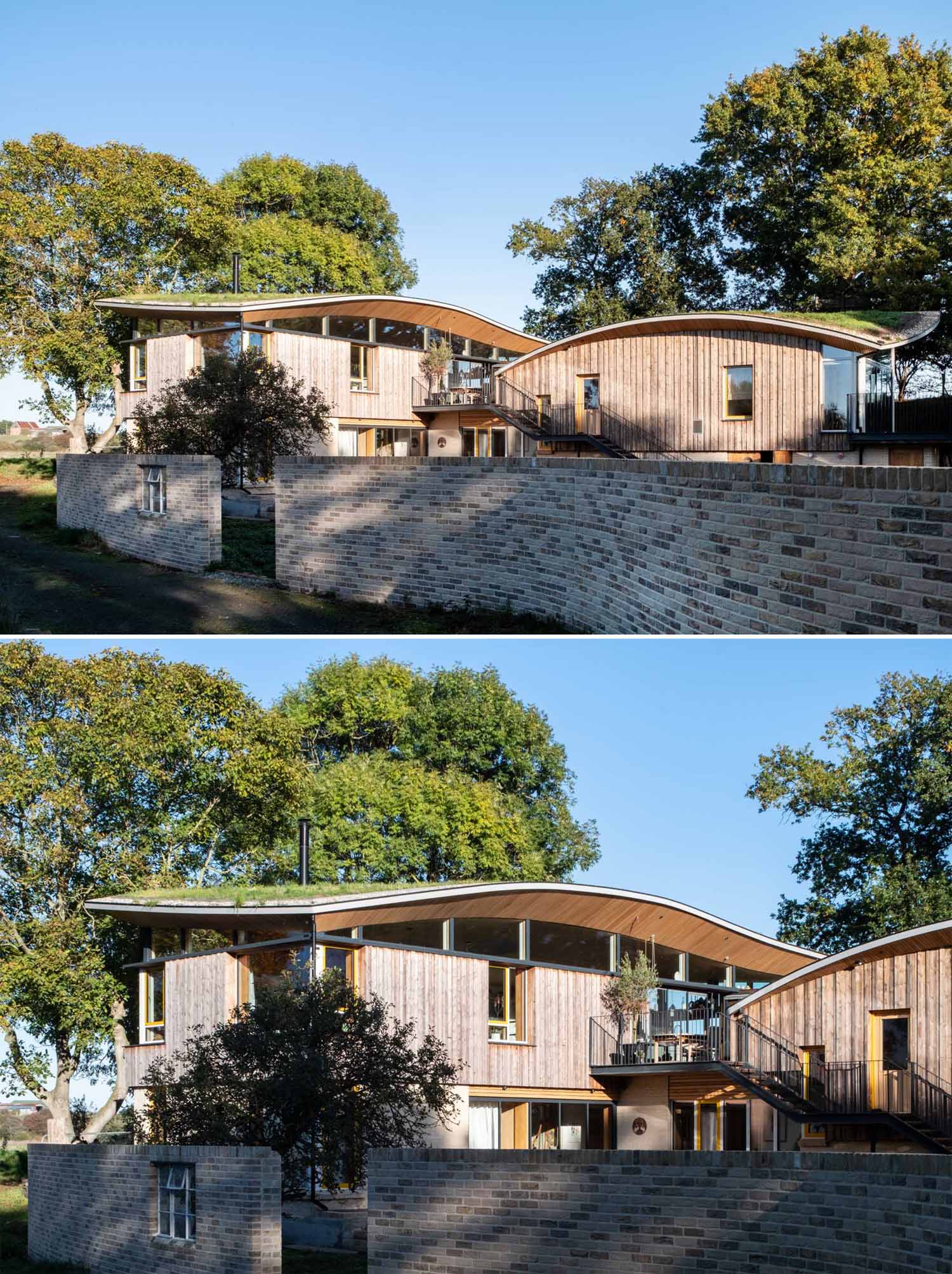 A modern cabin with overhanging wood-lined eaves and curved green roofs.