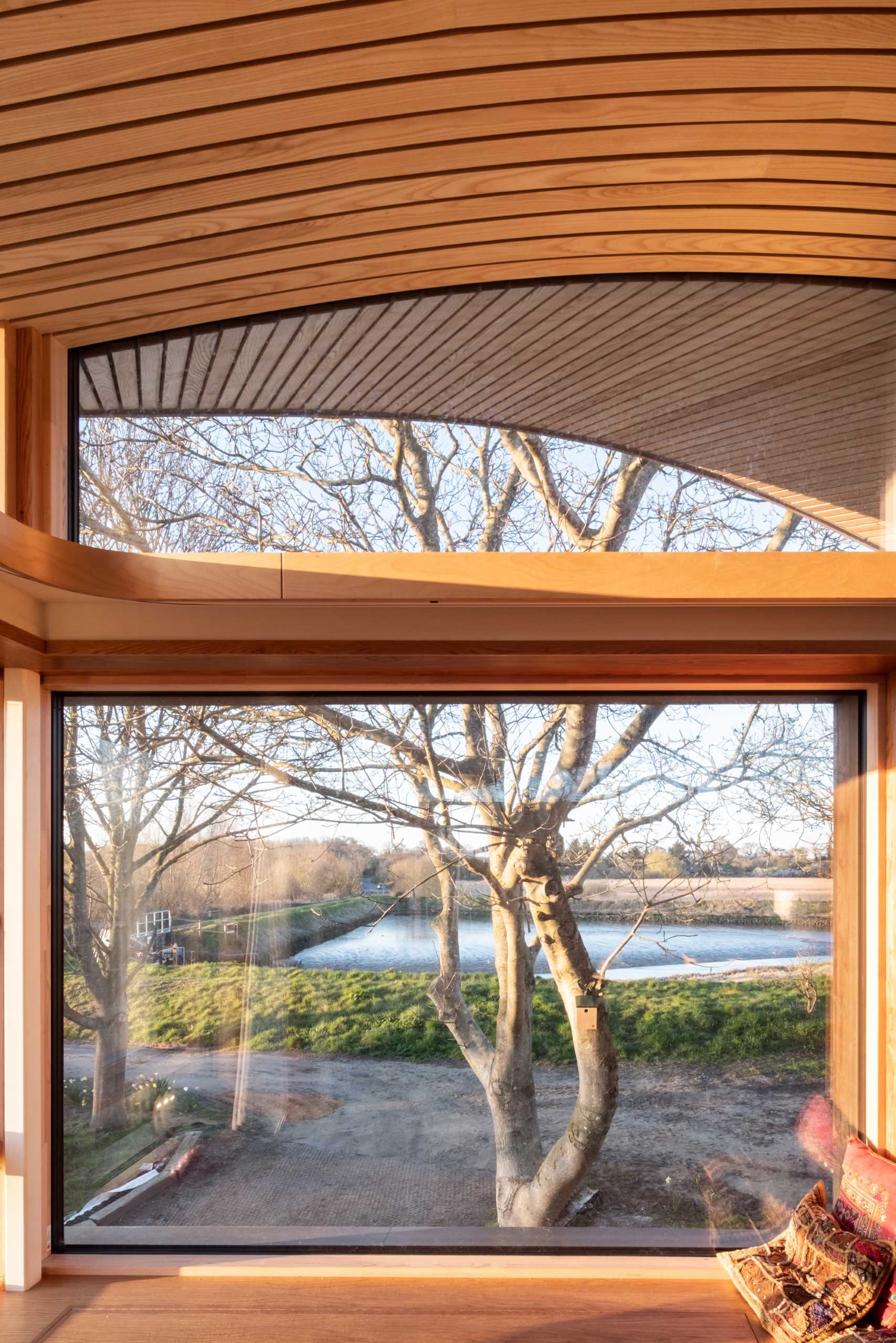 A contemporary cabin with windows that follow the roofline.