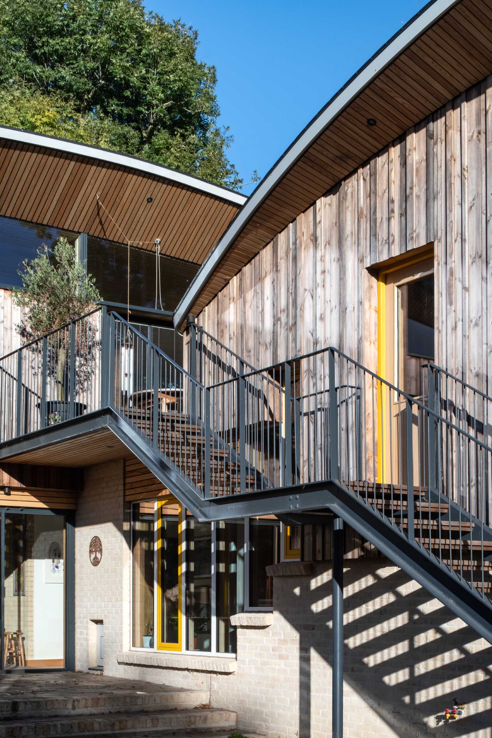 A modern cabin with overhanging wood-lined eaves.